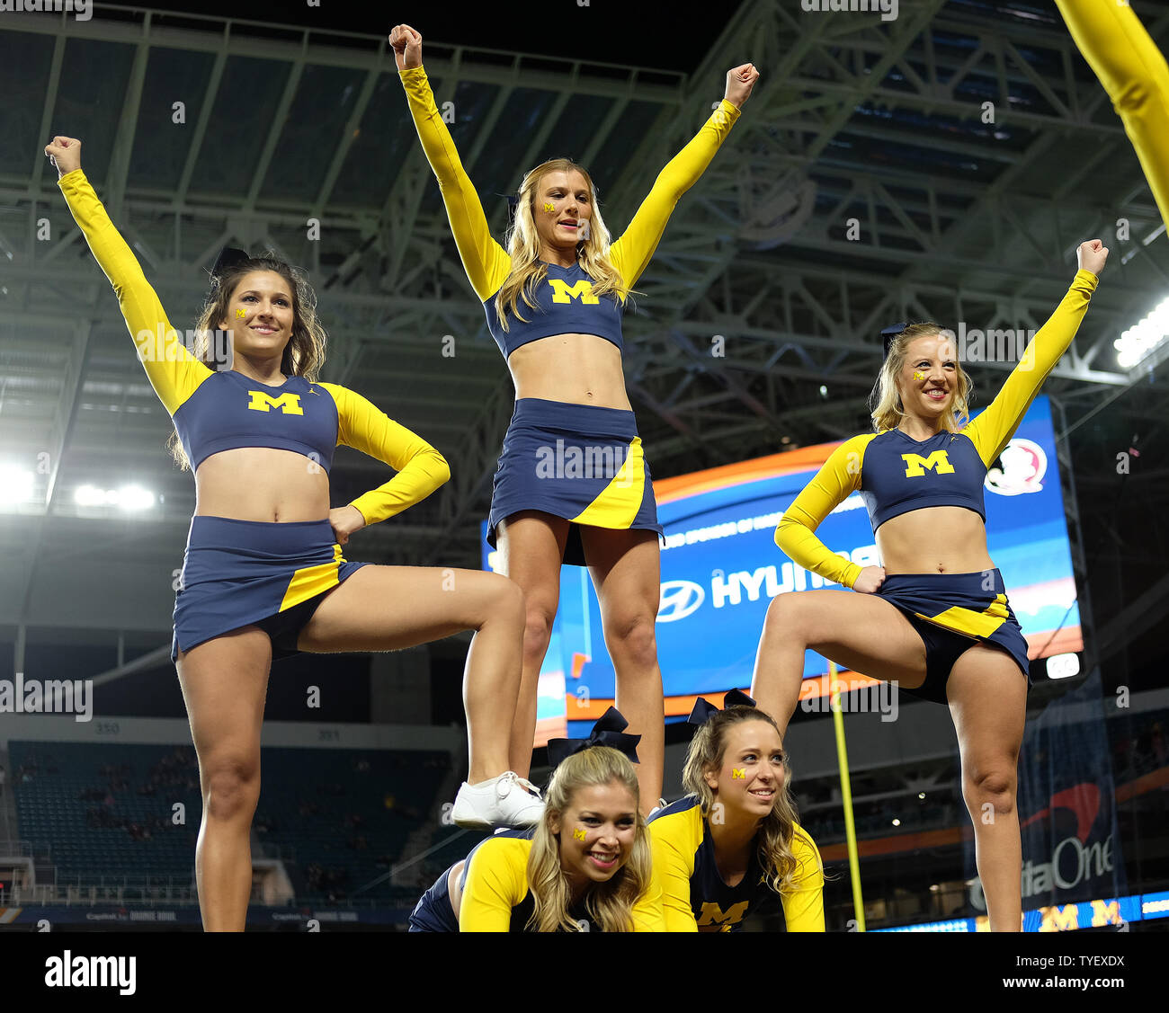 Michigan Wolverines cheerleaders practice their routines prior to the