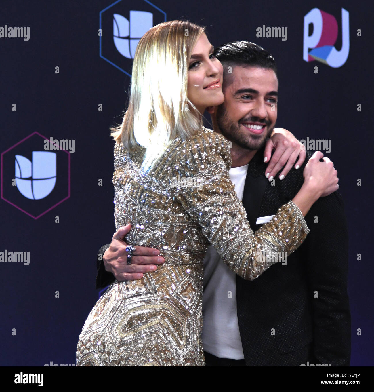 Daniela Di Giacomo (L) and Borja Voces walk the red carpet at the 2017  Premios Juventud event at the Wasco Center, University of Miami, Miami,  Florida on July 6, 2017. Photo by