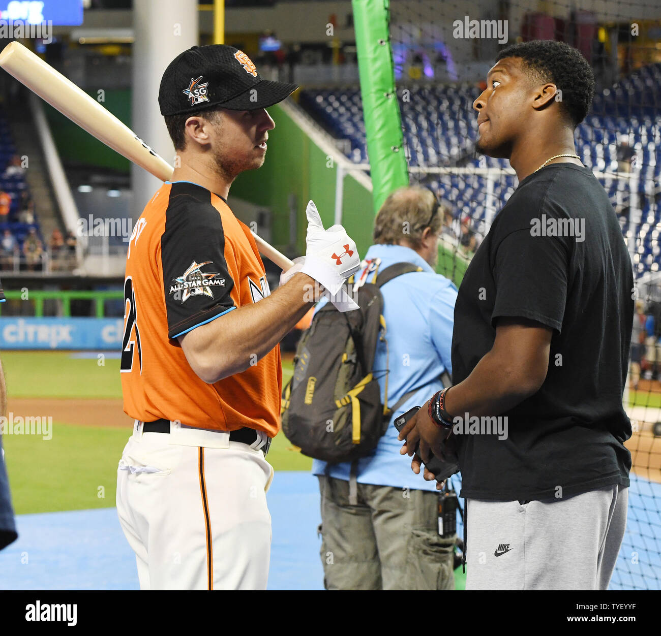 San Francisco Giants catcher Buster Posey talks with Tampa Bay Buccaneers quarterback James Winston during batting practice at  the 2017 MLB All-Star game at Marlins Park in Miami, Florida on July 11, 2017.      Photo by Gary I Rothstein/UPI Stock Photo
