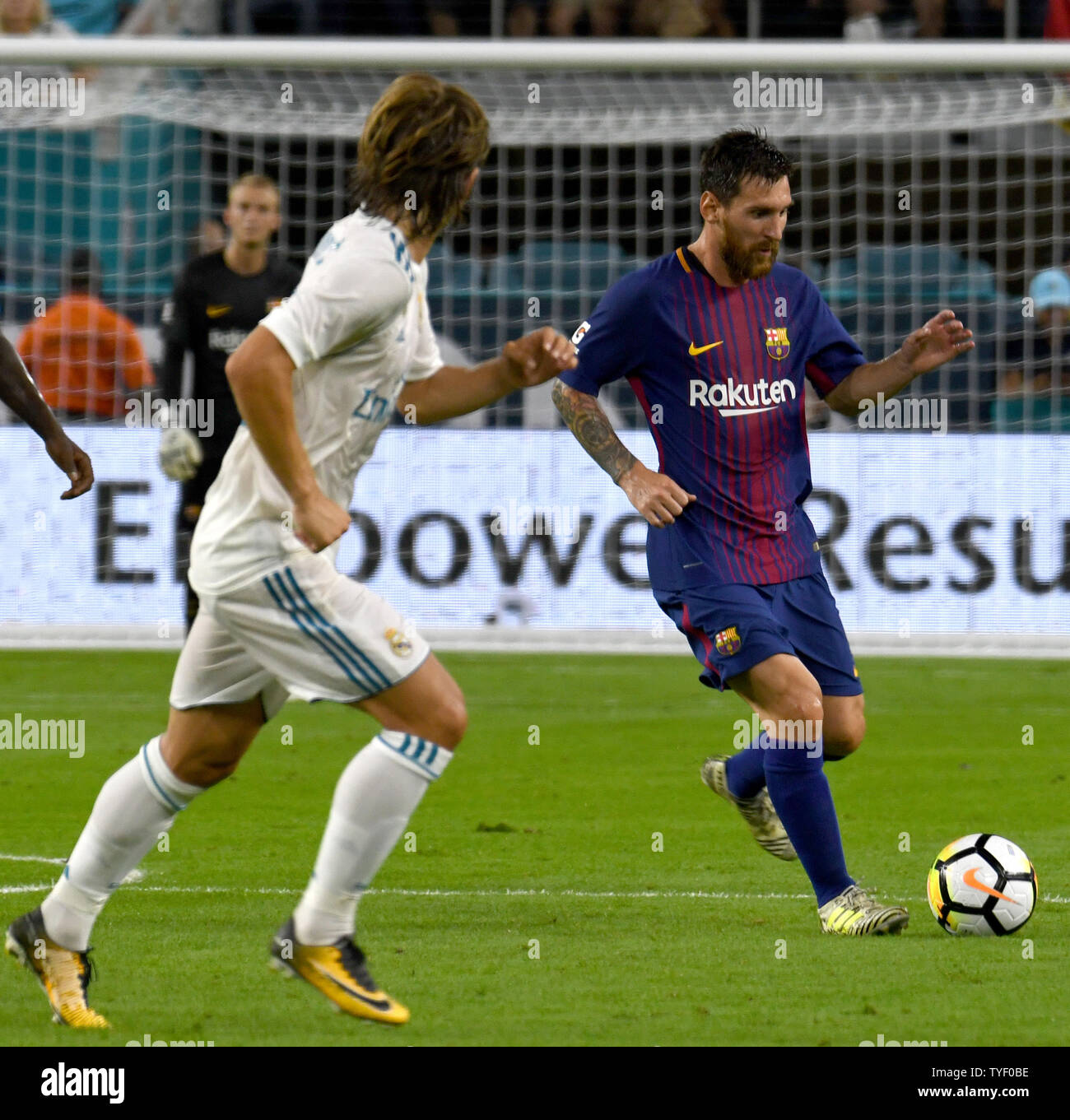 Barcelona's Lionel Messi (10) dribbles the ball past Real Madrid in the ...