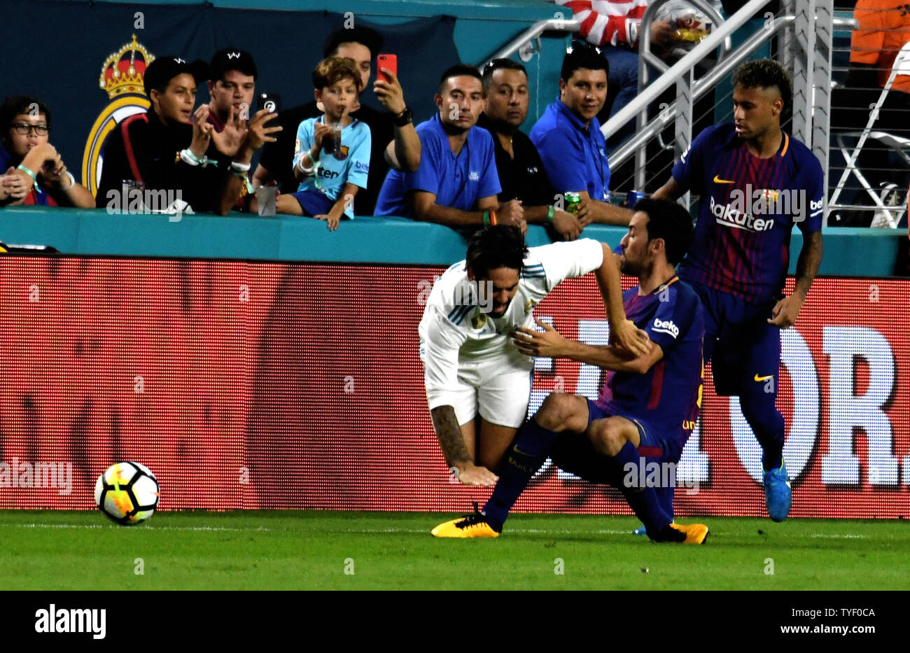 Barcelona's Sergio Busquets (5) tackles Real Madrid's Isco (22) in the