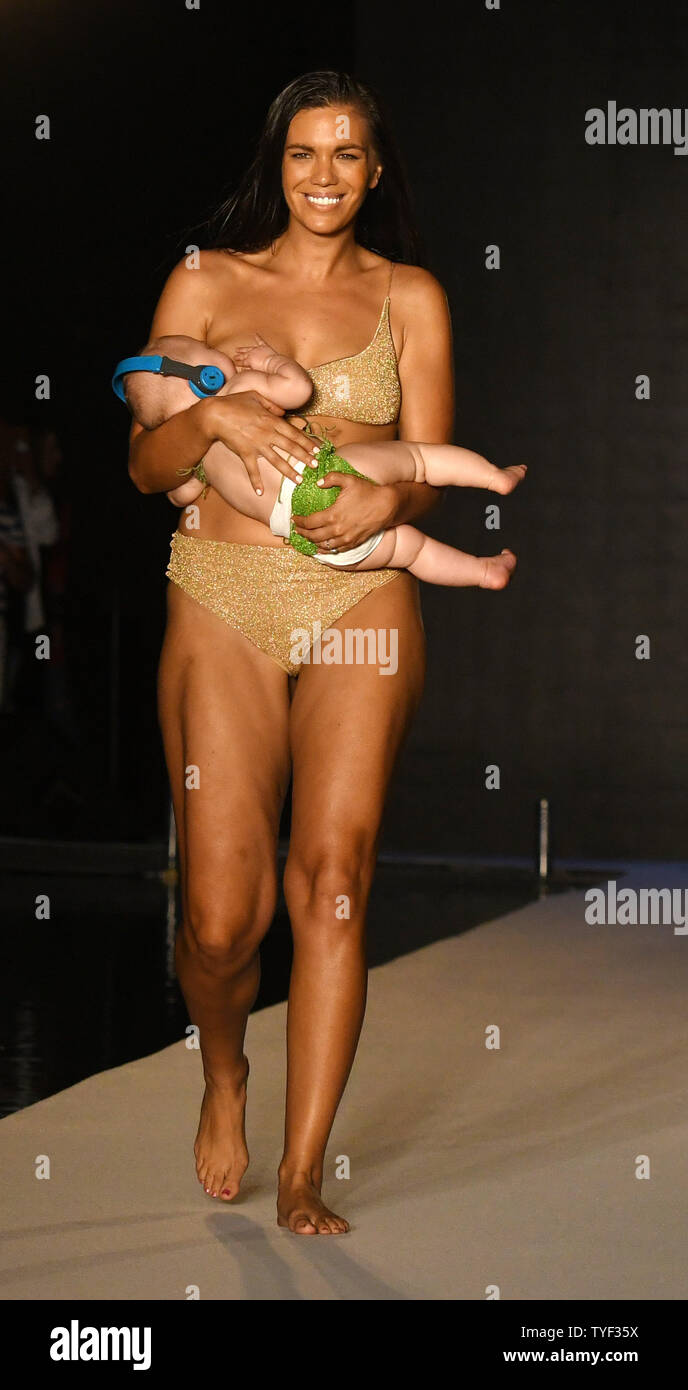 A model nursing her baby walks the runway during the 2018 Sports  Illustrated Swimsuit show at the W Hotel, Miami Beach, Florida, July 15,  2018. Over 2000 girls interviewed for two days