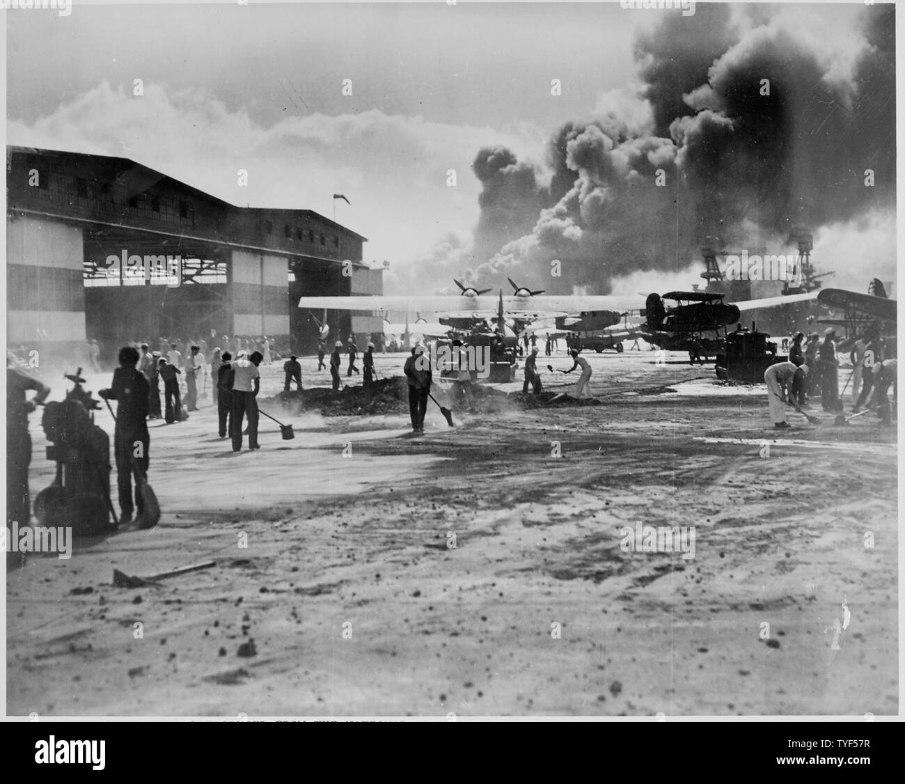 Photograph of the Repairs to the Apron at the Ford Island Naval Air Station, Hawaii; Scope and content:  This is a naval photograph documenting the Japanese attack on Pearl Harbor, Hawaii that initiated the United States' participation in World War II.   Original caption: Cleaning up the apron at Ford Island, Naval Air Station at Pearl Harbor, after the Japanese attack on Dec. 7, 1941. General notes:  This photograph was originally taken by a Naval photographer immediately after the Japanese attack on Pearl Harbor, but came to be filed in a writ of application for Habeas Corpus case number 298 Stock Photo