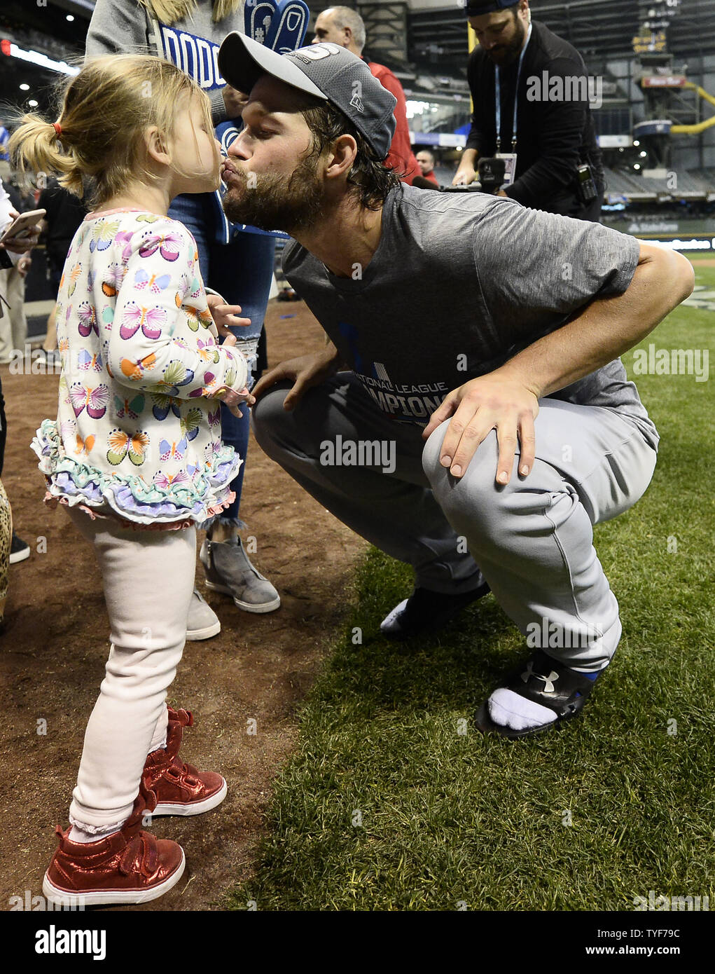 Los Angeles Dodgers pitcher Clayton Kershaw gives a victory kiss to his daughter  Cali Ann after the Dodgers beat the Milwaukee Brewers in National League  Championship Series game seven at Miller Park