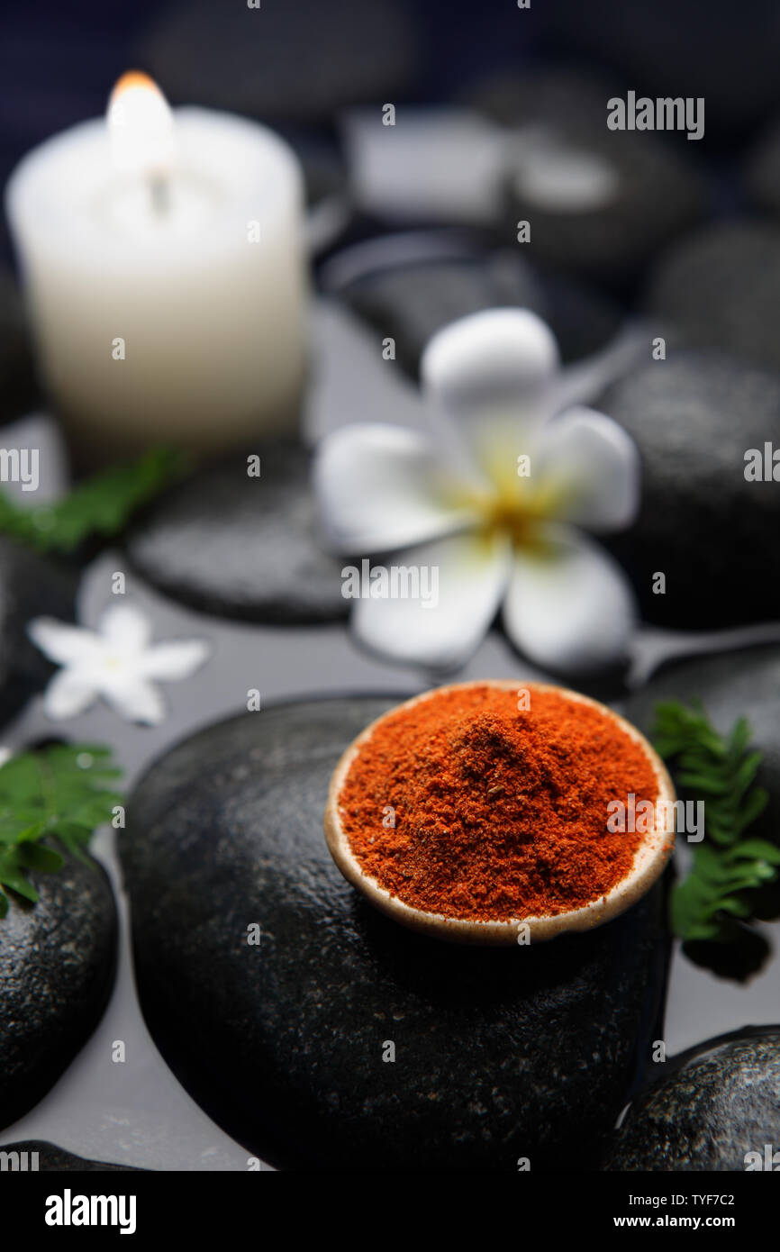 Herbal powder in a bowl on lastone therapy stone Stock Photo