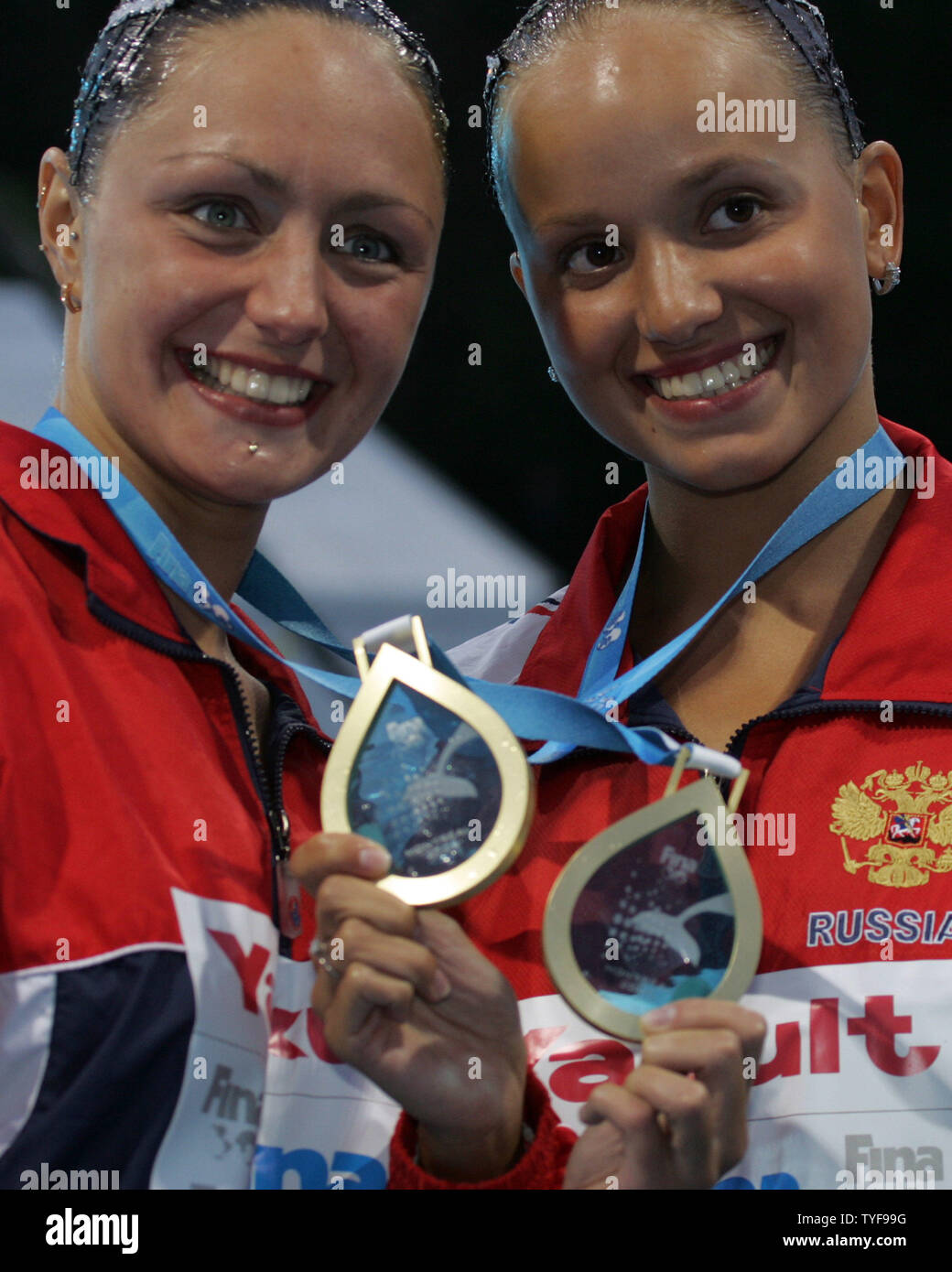 Russian synchronized swimmers Anastasia Davydova and Anastasia Ermakova brandish their gold medals from the duet competition at the XI FINA World Championships in Montreal, Canada on July 22, 2005.  The Anastasias dominated the competition earning six perfect 10.0 scores for a total of 99.667 points ahead of the Japanese and Spanish duets. (UPI Photo / Grace Chiu) Stock Photo