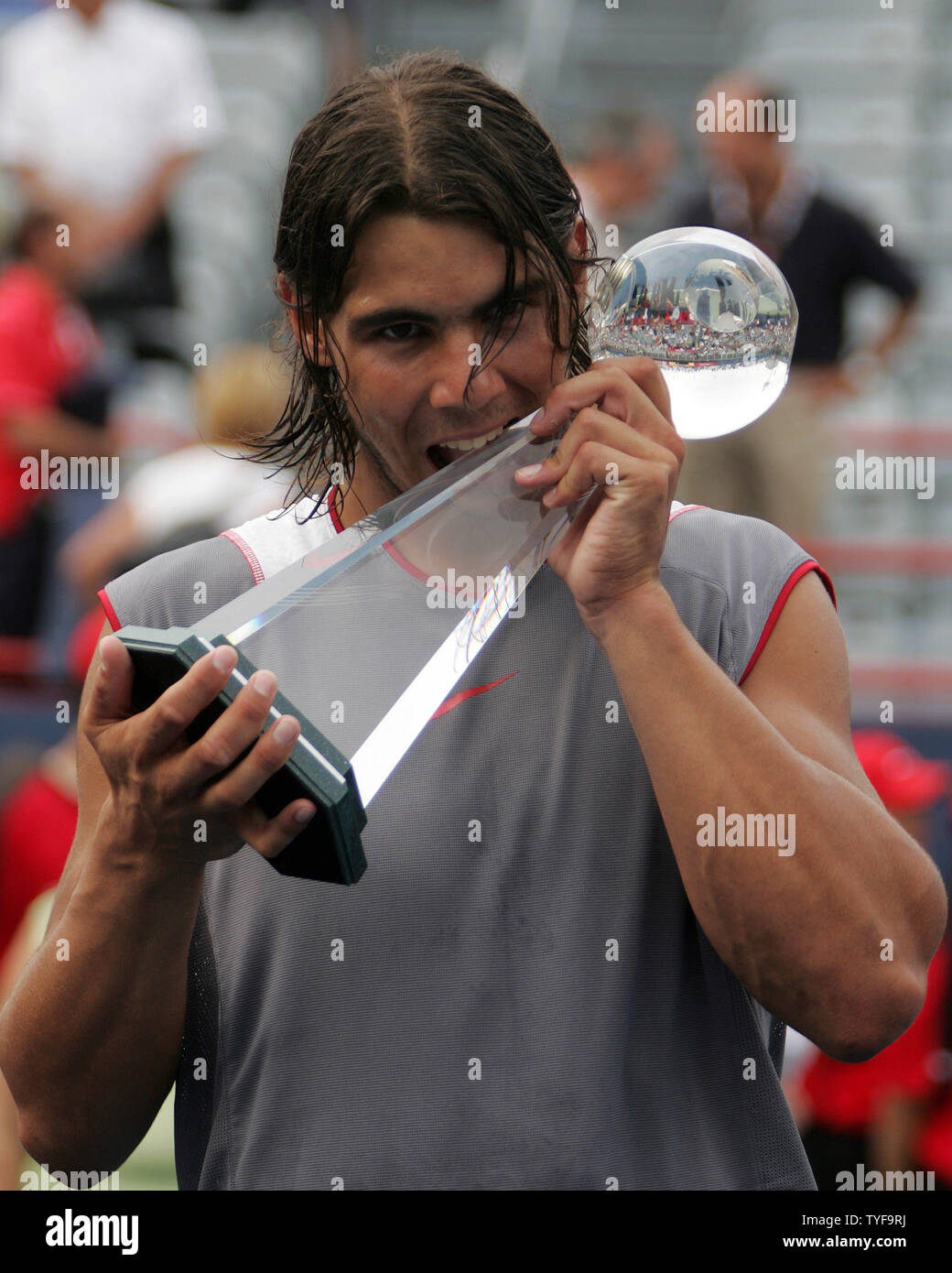 Spain's Rafael Nadal tastes the Rogers Cup trophy earned after winning the final match of the Rogers Cup men's tennis ATP masters tournament in Montreal on August 14, 2005. Nadal,19, defeated American Andre Agassi 6-3, 4-6, 6-2. (UPI Photo / Grace Chiu) Stock Photo