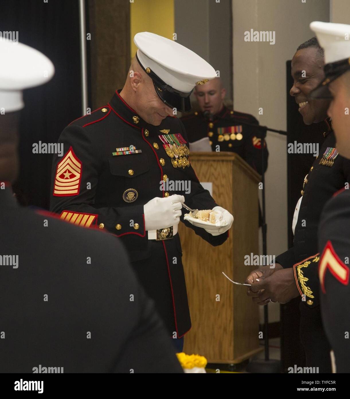 U.S. Marine Corps Sgt. Maj. Charles Metzger, left, sergeant major, Marine Corps Air Station New River (MCAS) receives birthday cake from Lt. Col. Quentin Vaughn, commanding officer, Headquarters and Headquarters Squadron (H&HS), during the H&HS MCAS New River 241st Marine Corps Birthday Ball at the Crystal Coast Civic Center, Morehead City, N.C., Nov. 5, 2016. The Marine Corps has carried 241 years of traditions, values and standards since its establishment in 1775. Stock Photo