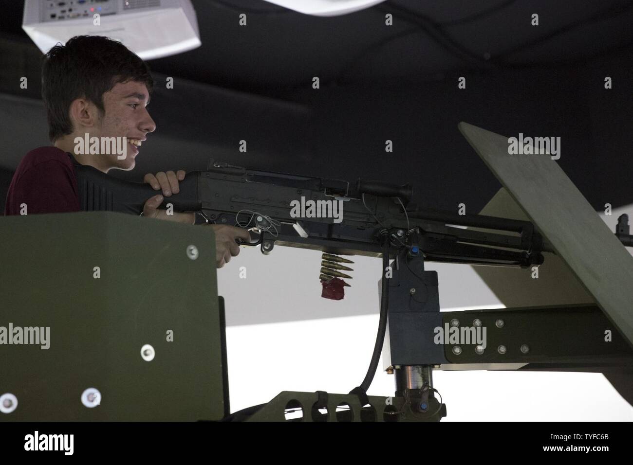 Jordan Foley, Boy Scout, Troop 377, fires a M249 Squad Automatic Weapon at the Convoy Combat Simulator aboard Marine Corps Air Ground Combat Center, Twentynine Palms, Calif., Nov. 5, 2016, during the Boy Scout Camp Out for local Boy Scouts of America troops. Stock Photo