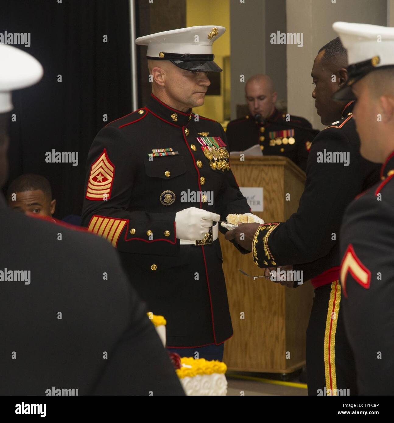 U.S. Marine Corps Sgt. Maj. Charles Metzger, left, sergeant major, Marine Corps Air Station New River (MCAS) receives birthday cake from Lt. Col. Quentin Vaughn, commanding officer, Headquarters and Headquarters Squadron (H&HS), during the H&HS MCAS New River 241st Marine Corps Birthday Ball at the Crystal Coast Civic Center, Morehead City, N.C., Nov. 5, 2016. The Marine Corps has carried 241 years of traditions, values and standards since its establishment in 1775. Stock Photo