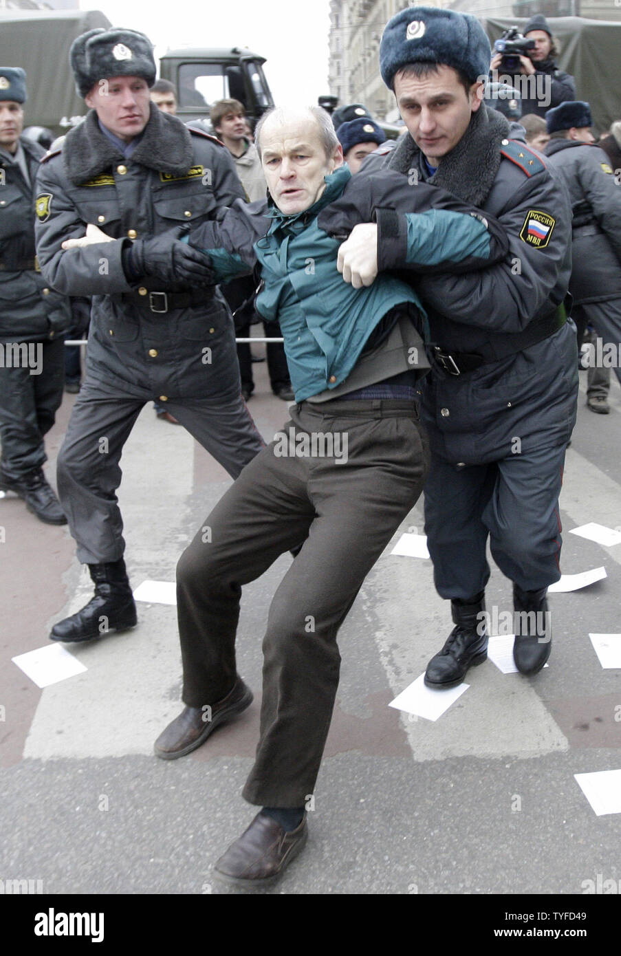 Russian riot police officers detain opposition activists during an  opposition rally called "Dissenter's March" in Moscow on December 14, 2008.  At least 150 people were arrested on Sunday in Moscow and St