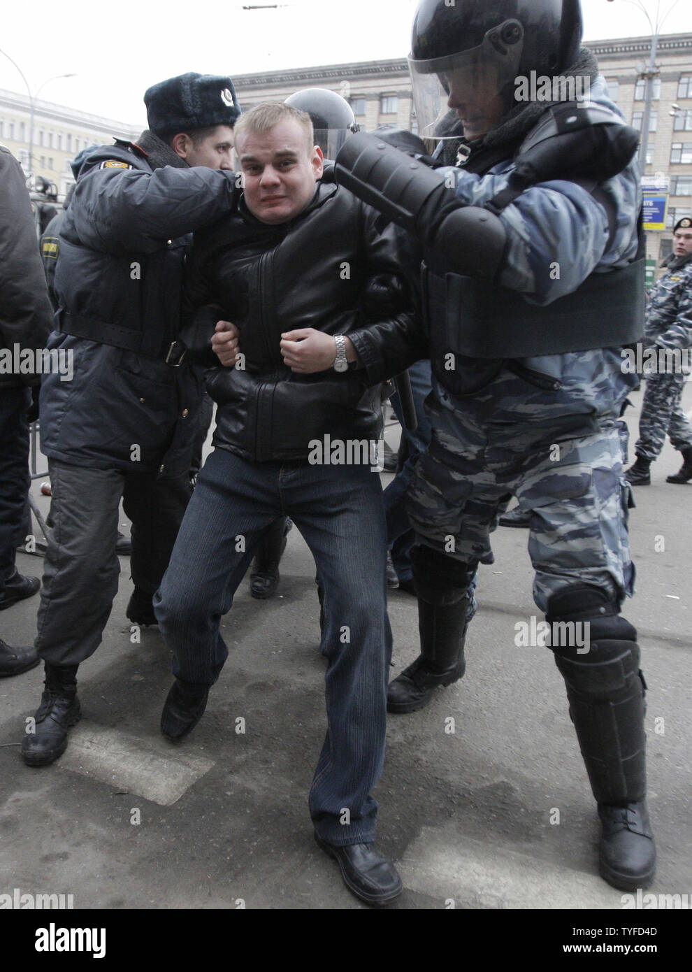 Russian riot police officers detain opposition activists during an  opposition rally called "Dissenter's March" in Moscow on December 14, 2008.  At least 150 people were arrested on Sunday in Moscow and St