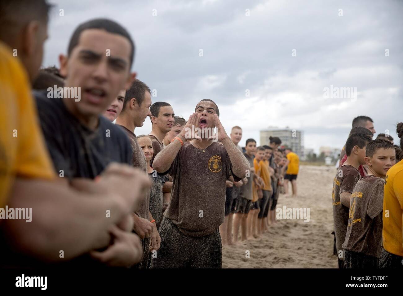FORT PIERCE, Fla. (Nov. 5, 2016) U.S. Naval Sea Cadet Corps Seaman Apprentice Cadiz, Centurion Battalion, shouts a rallying cry to his shipmates during beach physical training. Cadets perform a variety of types of community service benefiting their hometowns, including roadside and park clean-up efforts and volunteering at public libraries and museums. Cadets also provide support to veterans through outreach programs and honor guard detachments for memorial services. Stock Photo