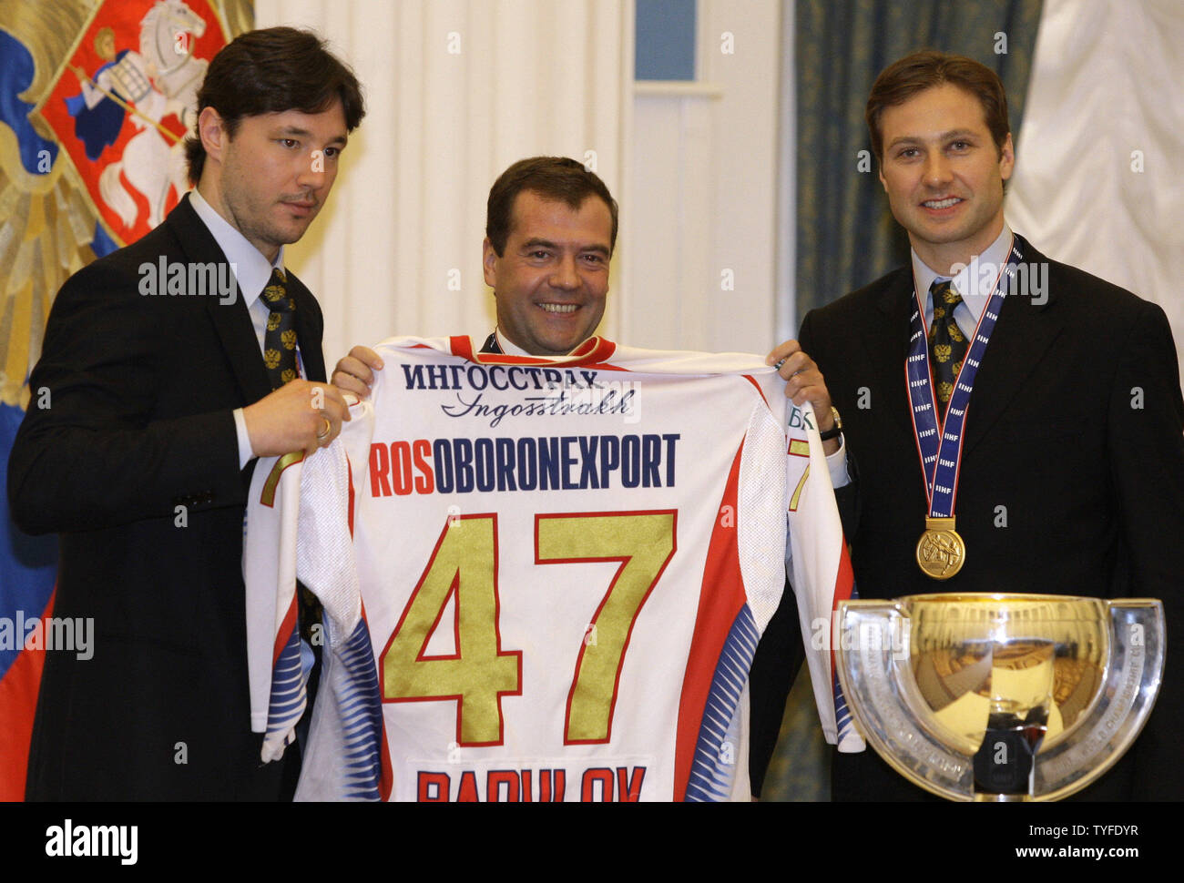 Russian President Dmitry Medvedev (C) holds a jersey of the national ice hockey team with player Iliya Kovalchuk (L) and captain Alexei Morozov during a celebration in the Kremlin in Moscow on May 12, 2009. In the final match on Sunday Russia beat Canada 2-1 and won the gold-medal of the ice hockey world championships. (UPI Photo/Anatoli Zhdanov) Stock Photo