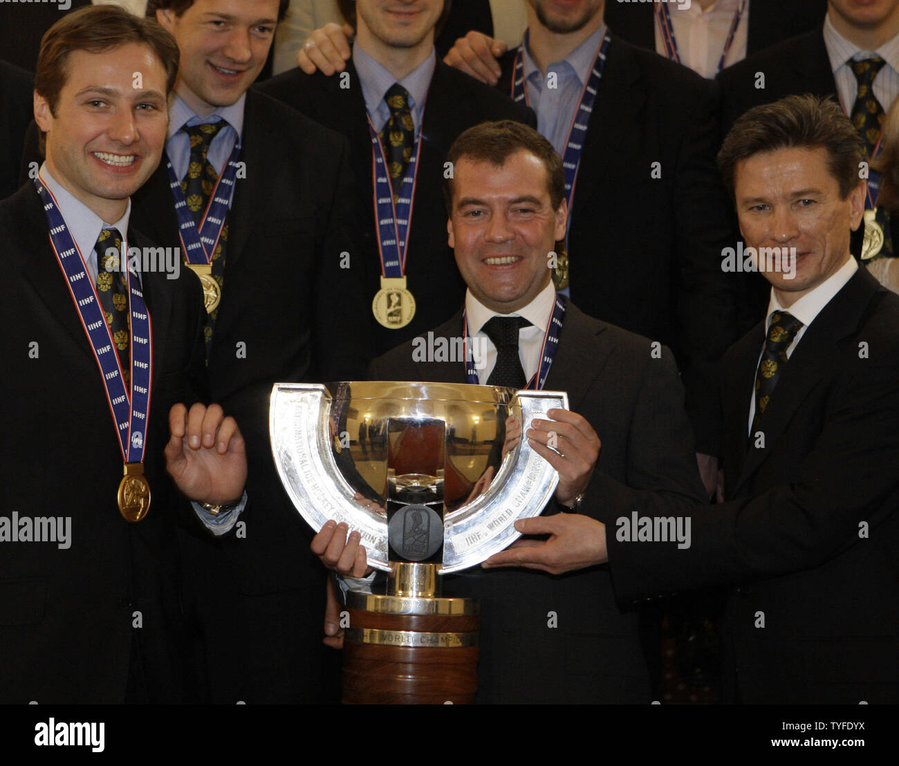 Russian President Dmitry Medvedev (C) holds the World Hockey Championships trophy with captain Alexei Morozov (L) and coach Vyacheslav Bykov (R) during his meeting with the national ice hockey team in the Kremlin in Moscow on May 12, 2009. In the final match on Sunday Russia beat Canada 2-1 and won the gold-medal of the ice hockey world championships. (UPI Photo/Anatoli Zhdanov) Stock Photo