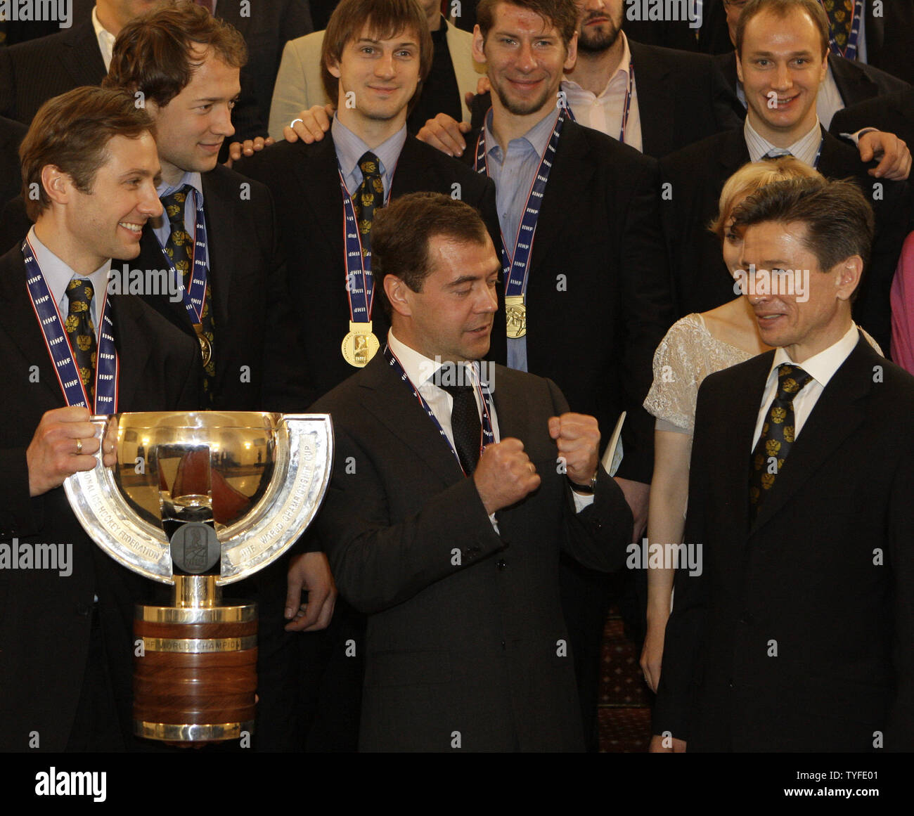 Russian President Dmitry Medvedev (C) talks to coach Vyacheslav Bykov as captain Alexei Morozov (L) holds the World Hockey Championships during a meeting with the national ice hockey team in the Kremlin in Moscow on May 12, 2009. In the final match on Sunday Russia beat Canada 2-1 and won the gold-medal of the ice hockey world championships. (UPI Photo/Anatoli Zhdanov) Stock Photo