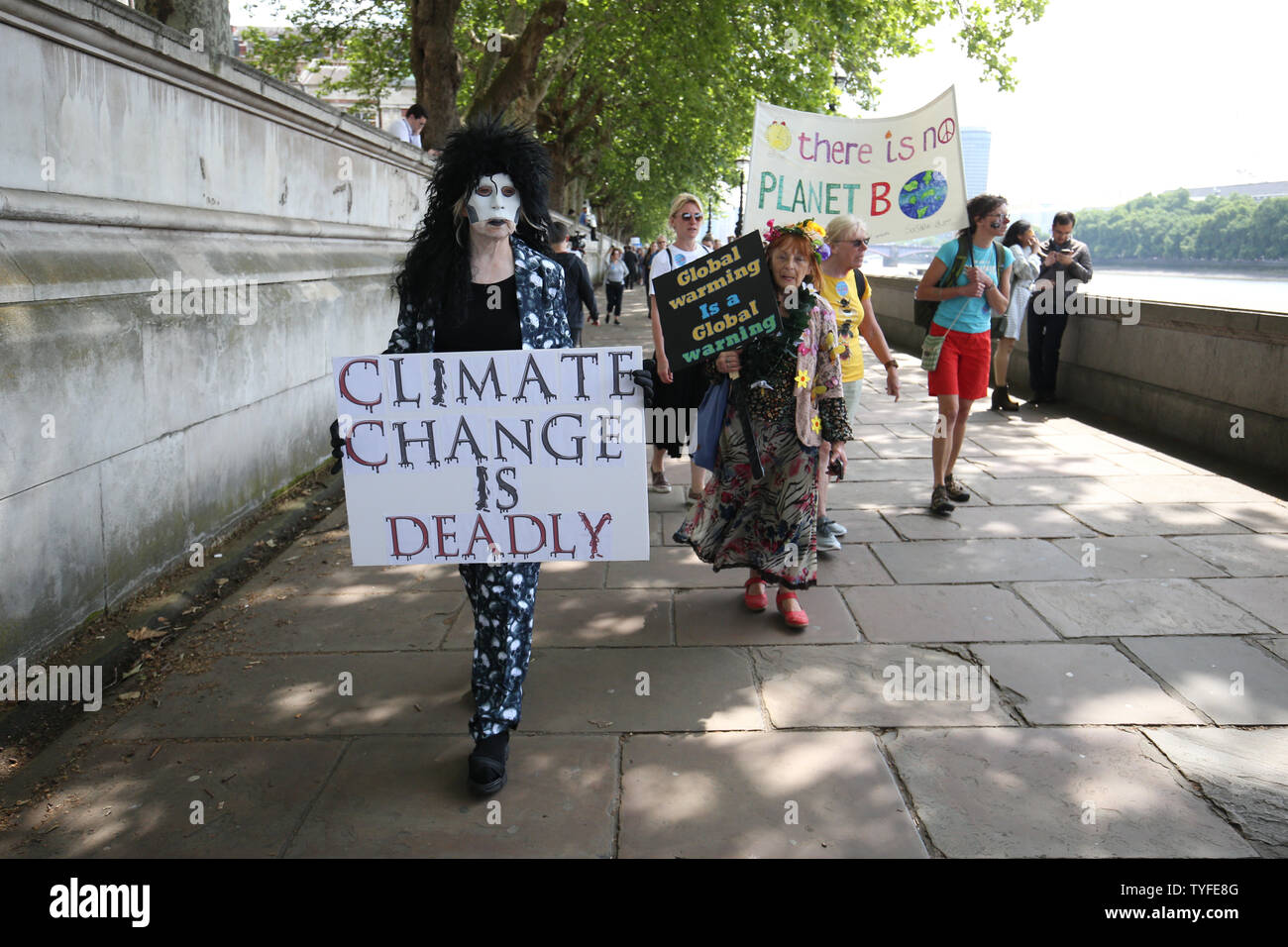 Climate activists walk along the Southbank, on their way to join the lobby of Parliament on taking action on climate change and environmental protection in Parliament Square, Westminster, London. Stock Photo