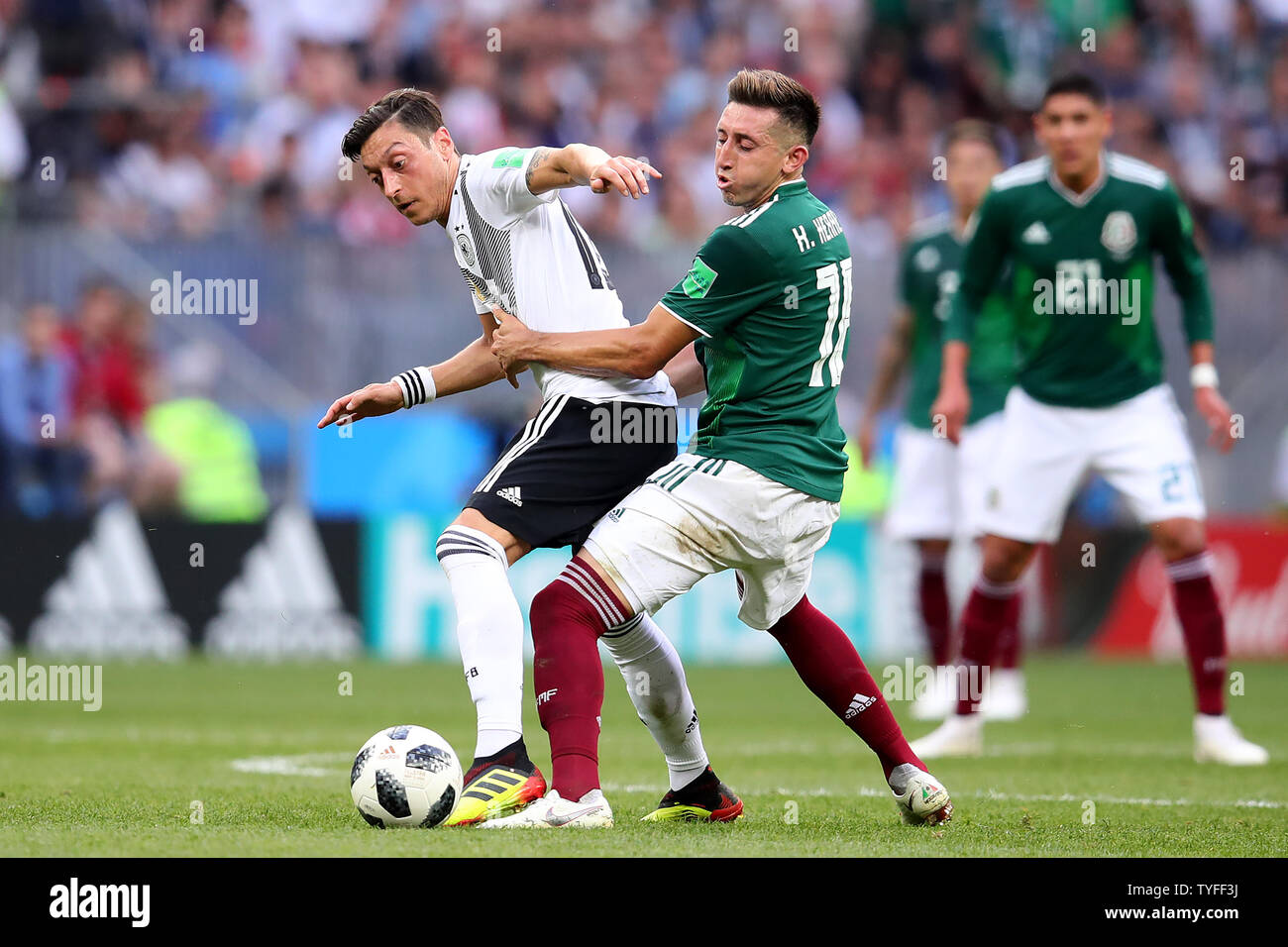 Messy Ozil (L) of Germany competes for the ball with Hector Herrera of Mexico during the 2018 FIFA World Cup Group F match at the Luzhniki Stadium in Moscow, Russia on June 17, 2018. Photo by Chris Brunskill/UPI Stock Photo