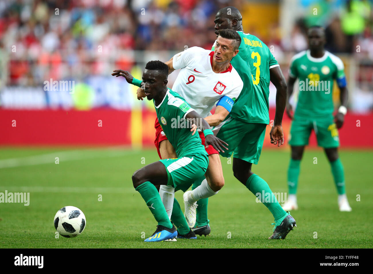 Robert Lewandowski of Poland (C) in action with Idrissa Gana Gueye (L) of Senegal during the 2018 FIFA World Cup Group H match at the Spartak Stadium in Moscow, Russia on June 19, 2018. Photo by Chris Brunskill/UPI Stock Photo