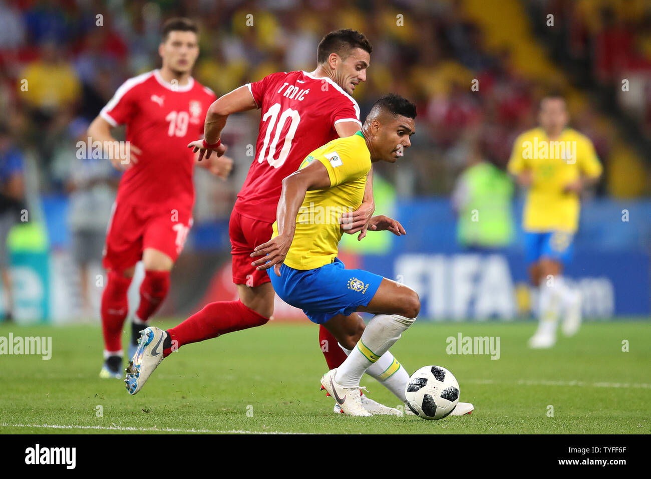 Casemiro (R) of Brazil is challenged by Dusan Tadic of Serbia during the 2018 FIFA World Cup Group E match at Spartak Stadium in Moscow, Russia on June 27, 2018. Brazil beat Serbia 2-0 to qualify for the round of 16. Photo by Chris Brunskill/UPI Stock Photo