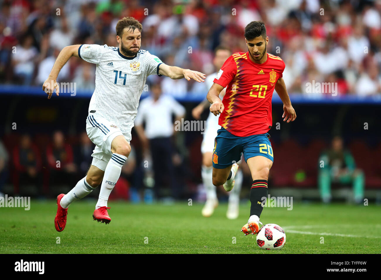 Marco Asensio (R) of Spain competes for the ball with Vladimir Granat of Russia during the 2018 FIFA World Cup Round of 16 match at Luzhniki Stadium in Moscow, Russia on July 1, 2018.  Russia beat Spain 4-2 on penalties to qualify for the quarter-finals. Photo by Chris Brunskill/UPI Stock Photo