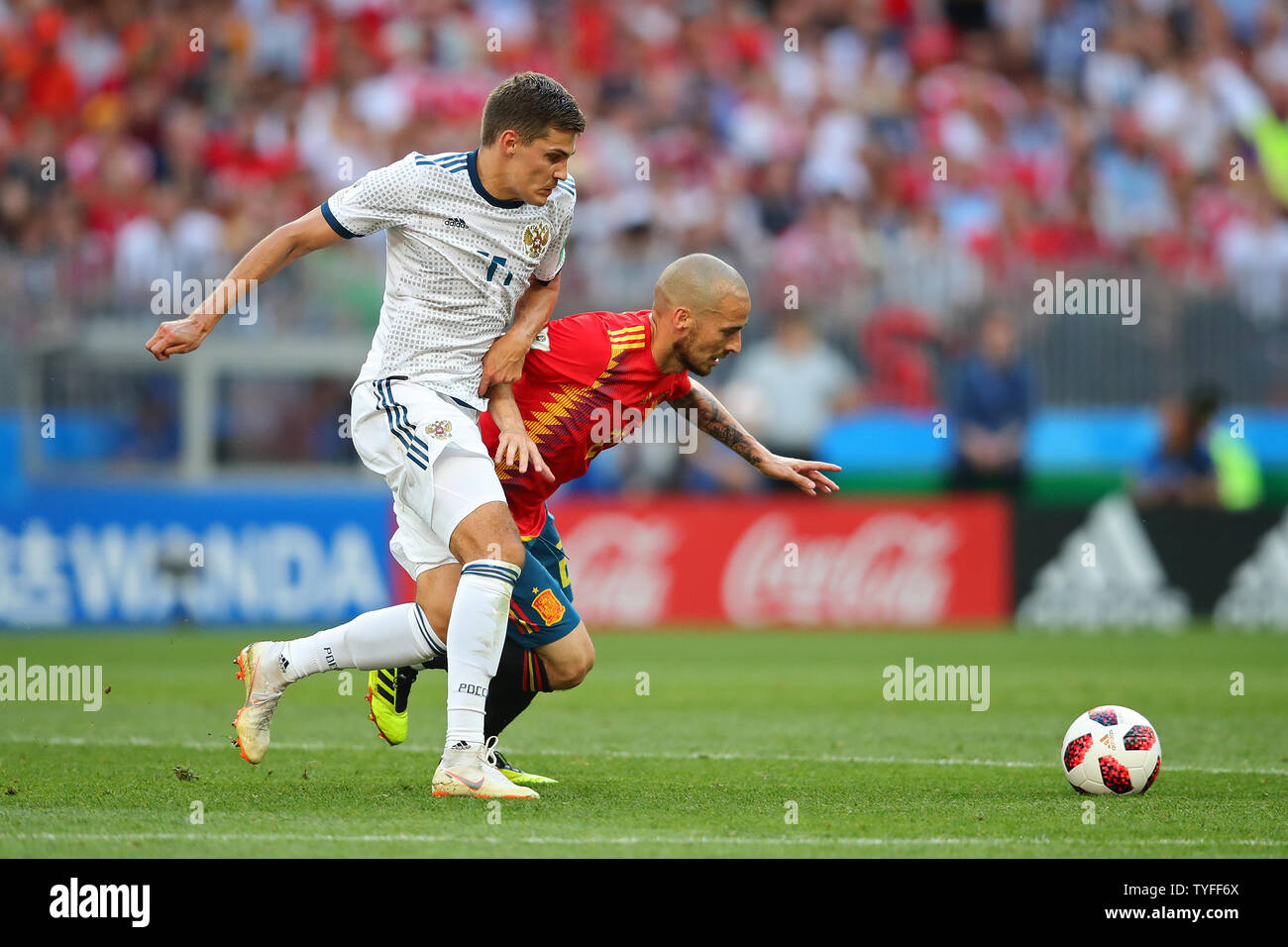 David Silva (R) of Spain competes for the ball with Roman Zobnin of Russia during the 2018 FIFA World Cup Round of 16 match at Luzhniki Stadium in Moscow, Russia on July 1, 2018.  Russia beat Spain 4-2 on penalties to qualify for the quarter-finals. Photo by Chris Brunskill/UPI Stock Photo
