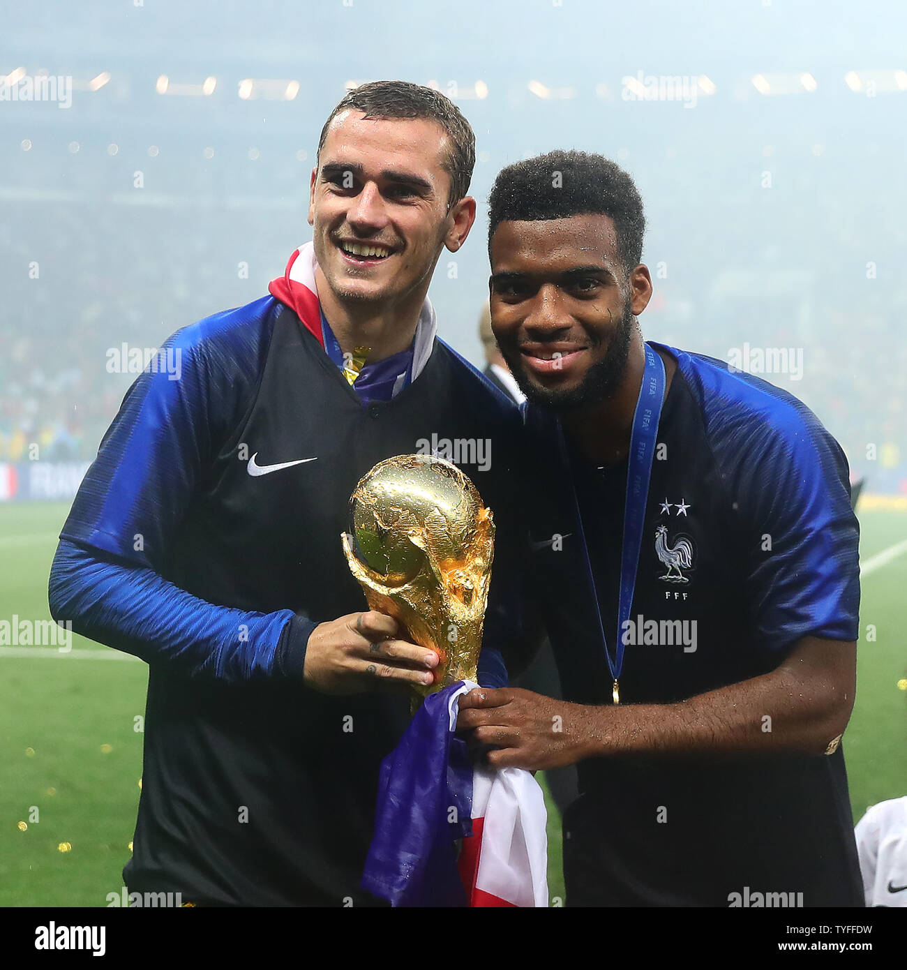 Antoine Griezmann (L) and Thomas Lemar of France celebrate with the trophy following the 2018 FIFA World Cup final match at Luzhniki Stadium in Moscow, Russia on July 15, 2018