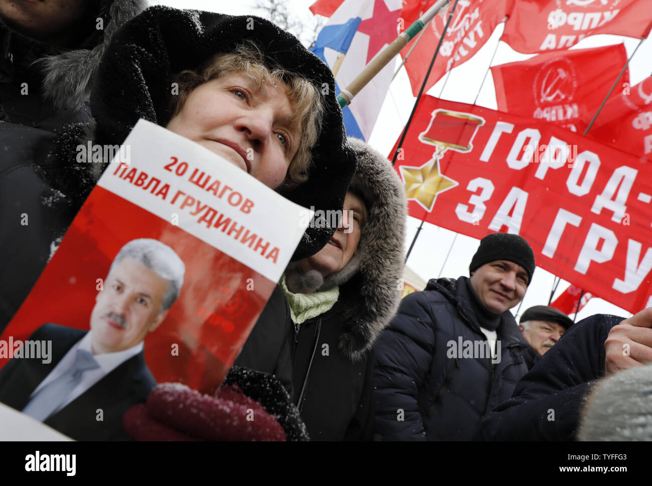 A woman holds portrait of Pavel Grudinin, presidential hopeful of the Russian Communist Party, during a rally for fair elections in Moscow on March 10, 2018. The placard is reads in Russian as 20 steps of Pavel Grudinin. Grudinin is considered as main  presidential candidate behind Vladimir Putin. Photo by Yuri Gripas/UPI Stock Photo