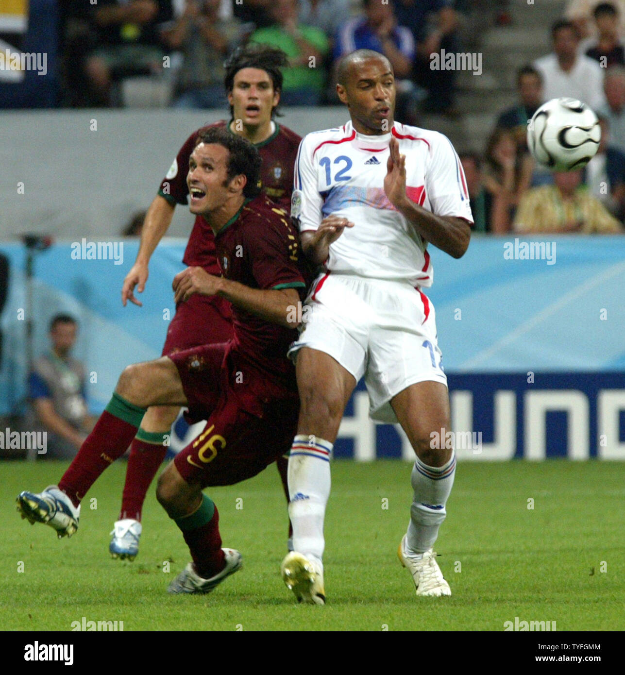 Thierry Henri of France (12) battles Portugal's Ricardo Carvalho (16) fight for the ball in World Cup soccer in Munich, Germany on July 5, 2006. France defeated Portugal 1-0.   (UPI Photo/Arthur Thill) Stock Photo