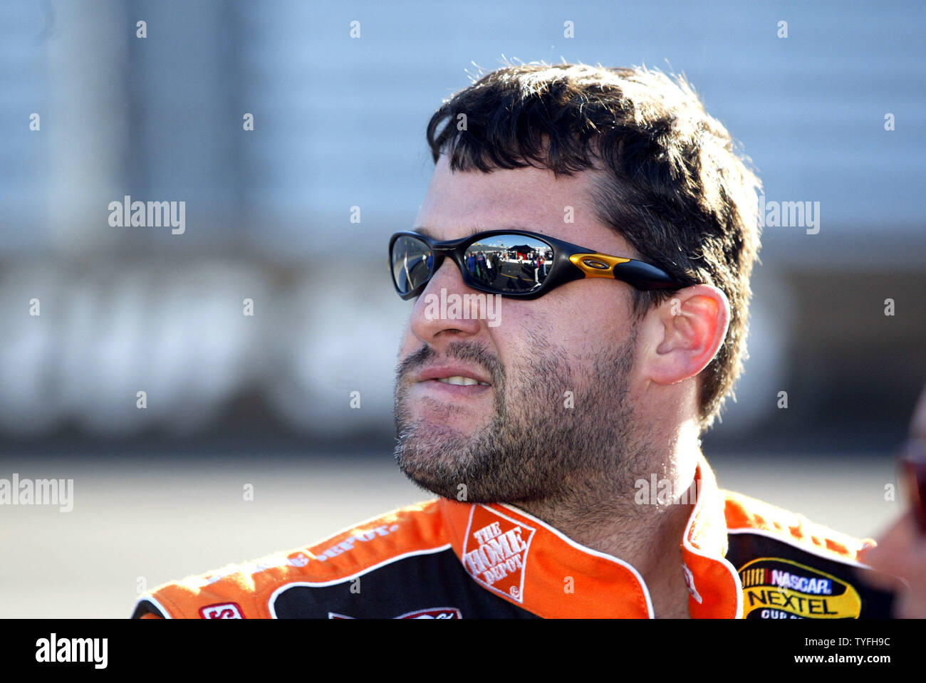 Race car driver Tony Stewart watches qualifying for the Subway 500