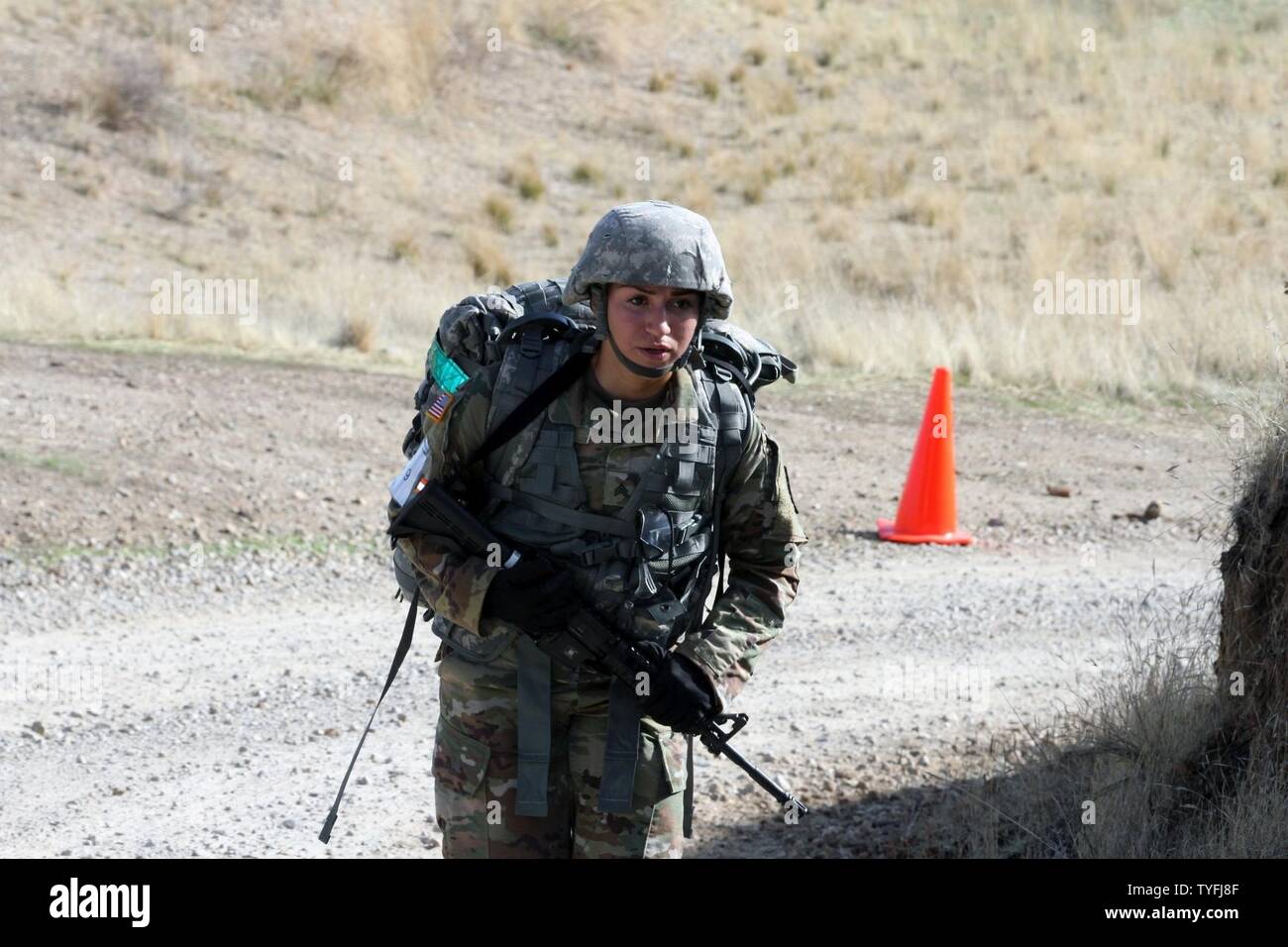 Sgt. Natalie Aquino, 870th Military Police Company, 49th Military Police Brigade, California Army National Guard, carries a 35-pound pack and closes on the 11-mile Ruck Sack finish line during California’s 2017 Best Warrior Competition Nov. 1-5, 2016, at Camp San Luis Obispo, San Luis Obispo, California. Stock Photo