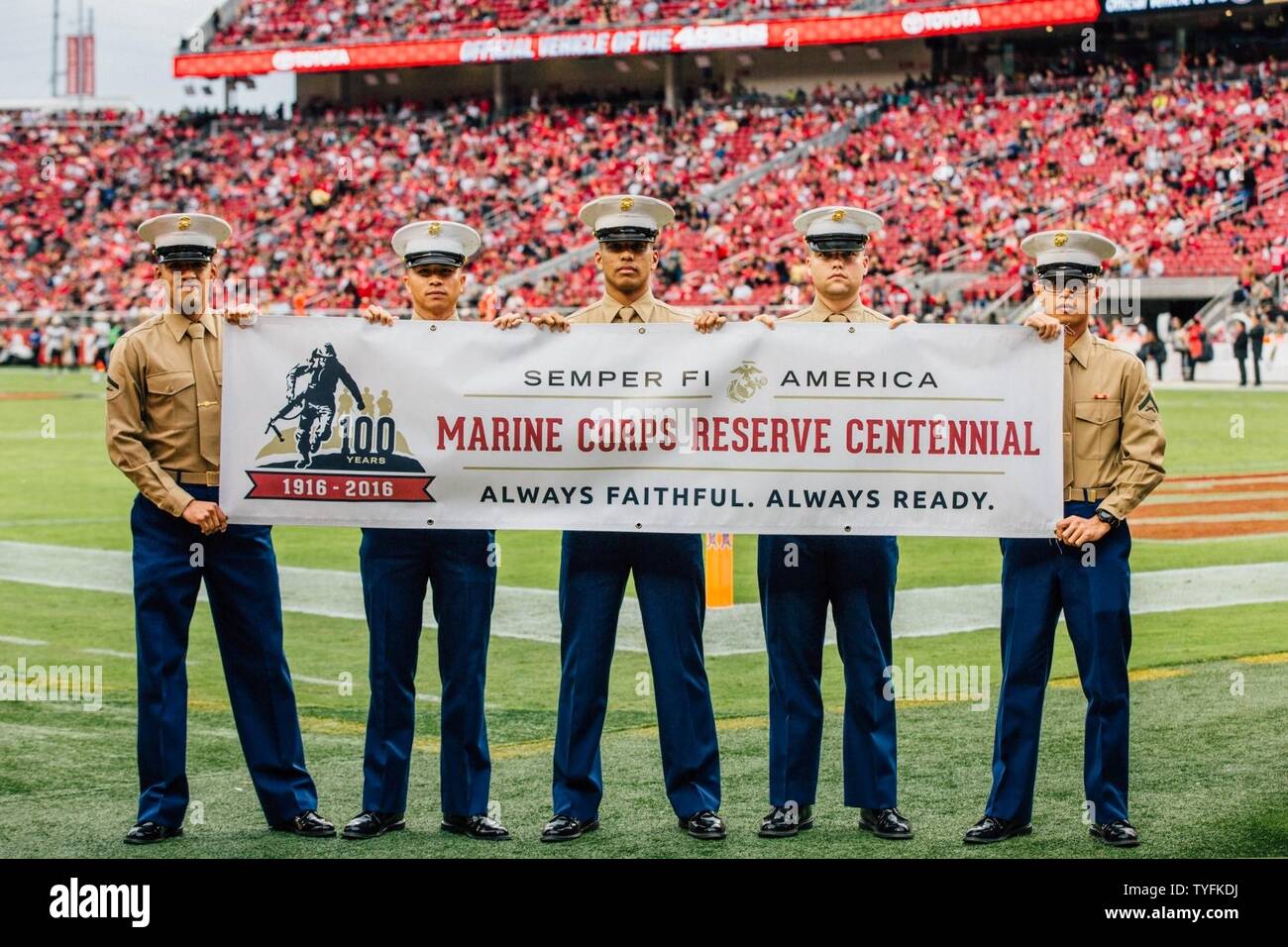 Marines from the San Francisco Bay Area hold the Marine Forces Reserve Centennial banner after the half-time show of the San Francisco 49ers’ game against the New Orleans Saints at Levi’s Stadium, Nov. 6, 2016. The National Football League recognized the Marine Corps Reserve’s Centennial during the half-time show as part of their “Salute to Service” campaign. Today, approximately 500 Reserve Marines are providing fully integrated operational support to Fleet and Combatant Commanders around the world. Stock Photo