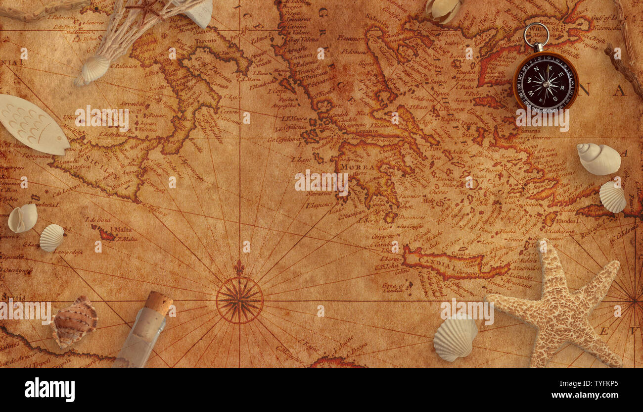 Old marine map with shells, a bottle with a message and an old compass. Copy space in the middle. Stock Photo