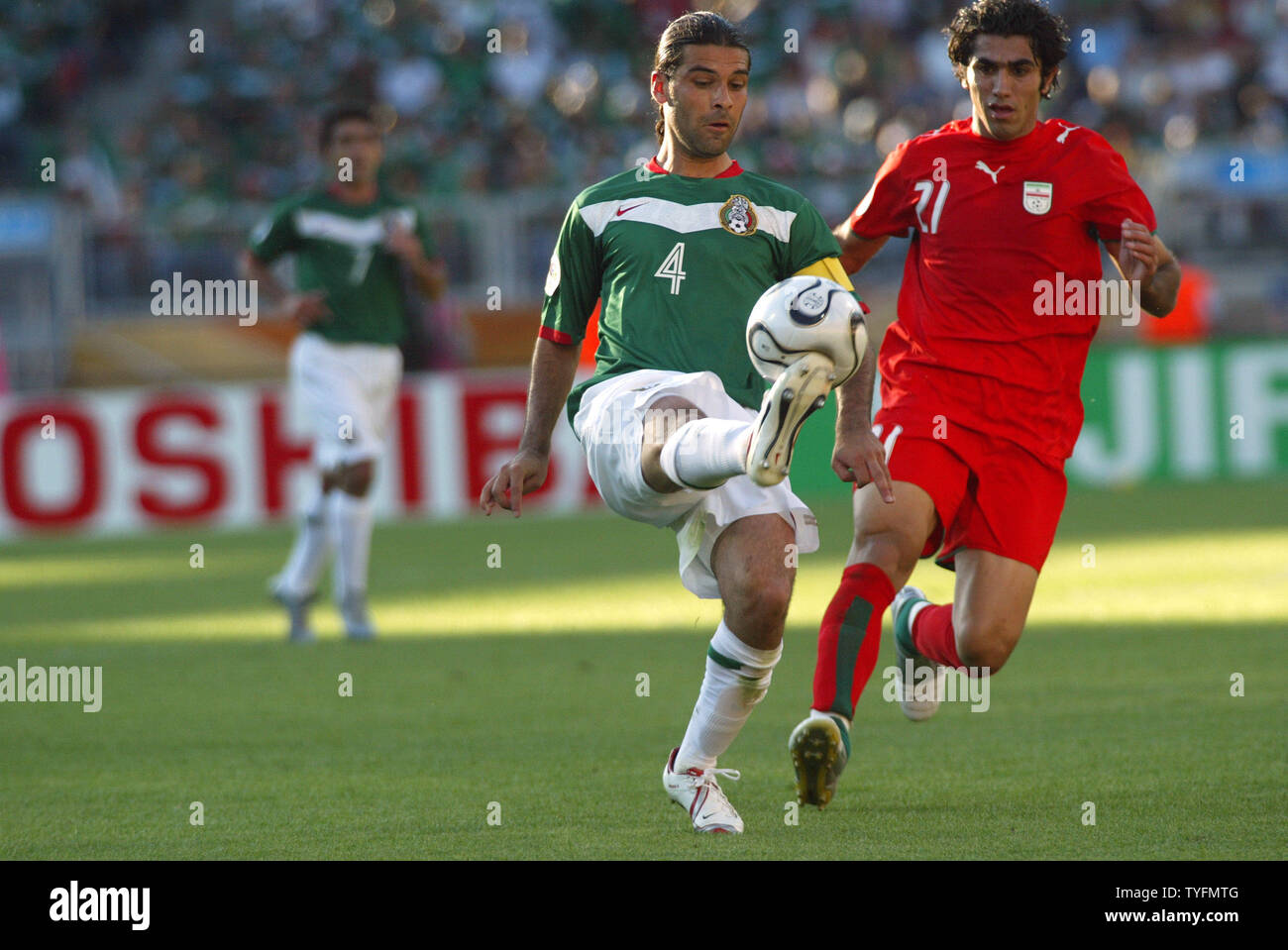 Mexican player Rafael Marquez (4) dominates Irans Mehrzad Madanchi (21) in a World Cup match in Nuernberg on June 11, 2006. Mexico won 3-1.  (UPI  Photo/Arthur Thill) Stock Photo
