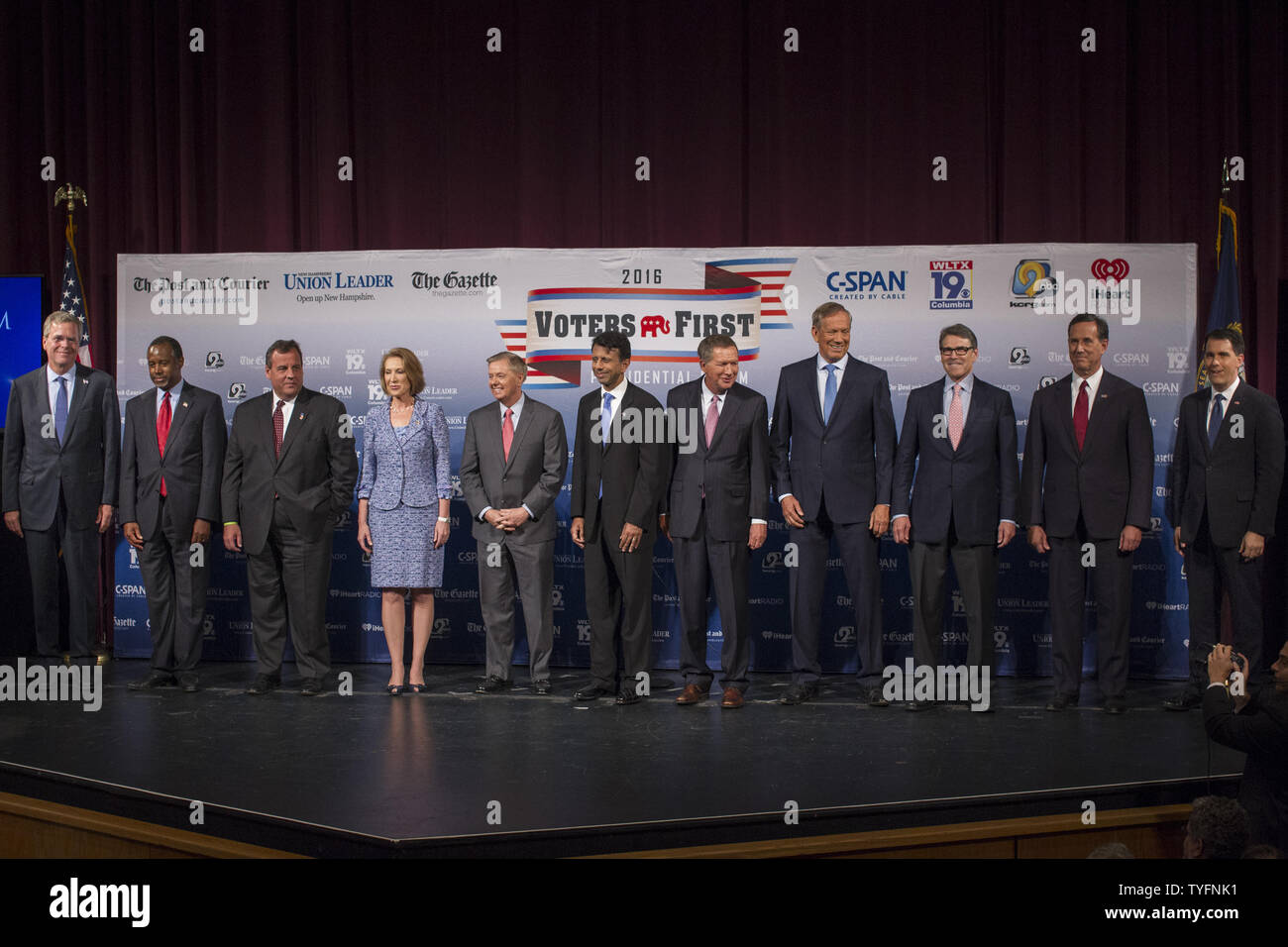 Republican presidential candidates, from left to right, Jeb Bush, Ben Carson, Gov. Chris Christie (R-NJ), Carly Fiorina, Sen. Lindsey Graham (R-NC), Gov. Bobby Jindal (R-LA), Gov. John Kasich (R-OH), George Pataki, Rick Perry, Rick Santorum and Gov. Scott Walker (R-WI), arrive on stage for the Voters First forum at St. Anselm College in Manchester, New Hampshire on August 3, 2015. Fourteen Republican presidential candidates, three via satellite,  excluding Donald Trump, participated in the forum which kicked off the Presidential debate schedule for the 2016 presidential election. Photo by Matt Stock Photo