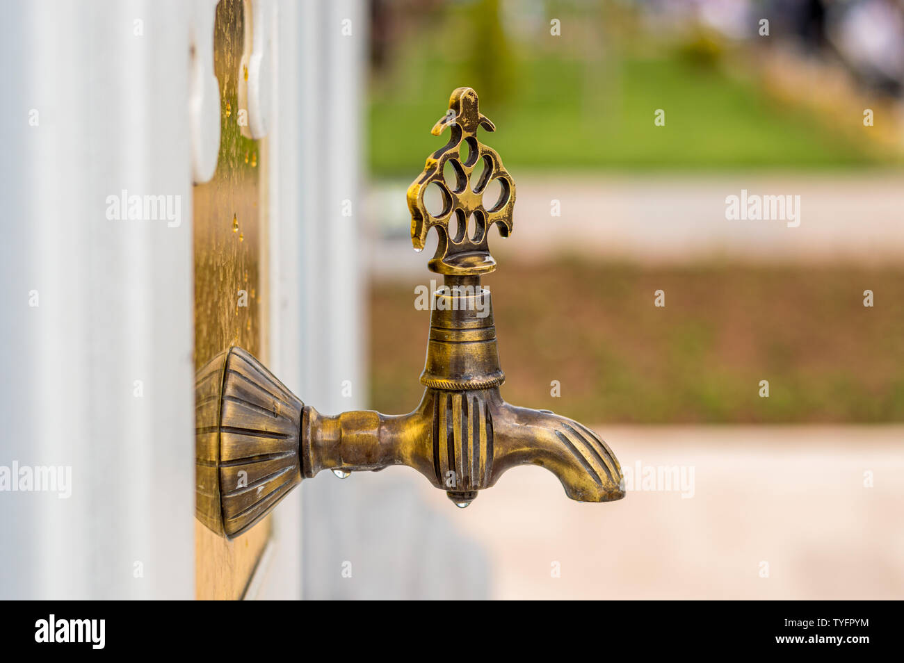Close up of an antique Turkish faucet in the garden. Old, historical