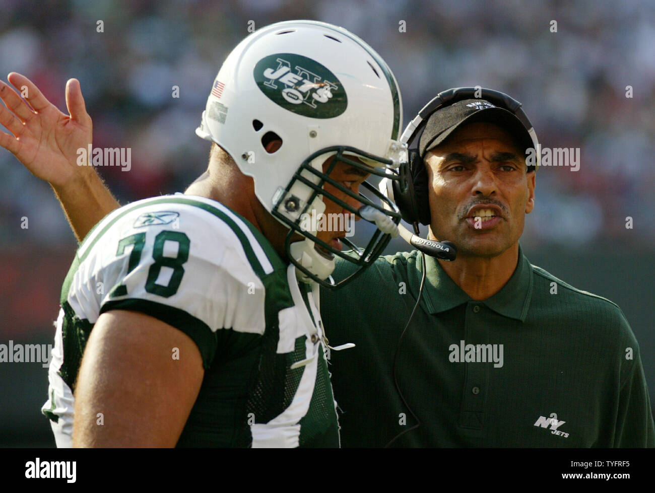 New York Jets head coach Herm Edwards pats Jonathan Goodwin on the
