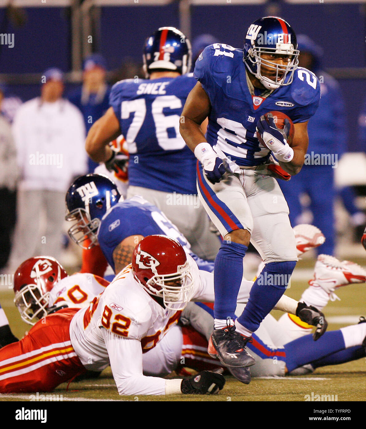 New York Giants runningback Tiki Barber leaps over defenders in week 15 at  Giants Stadium in East Rutherford, New Jersey on December 17, 2005. The New  York Giants defeated the Kansas City