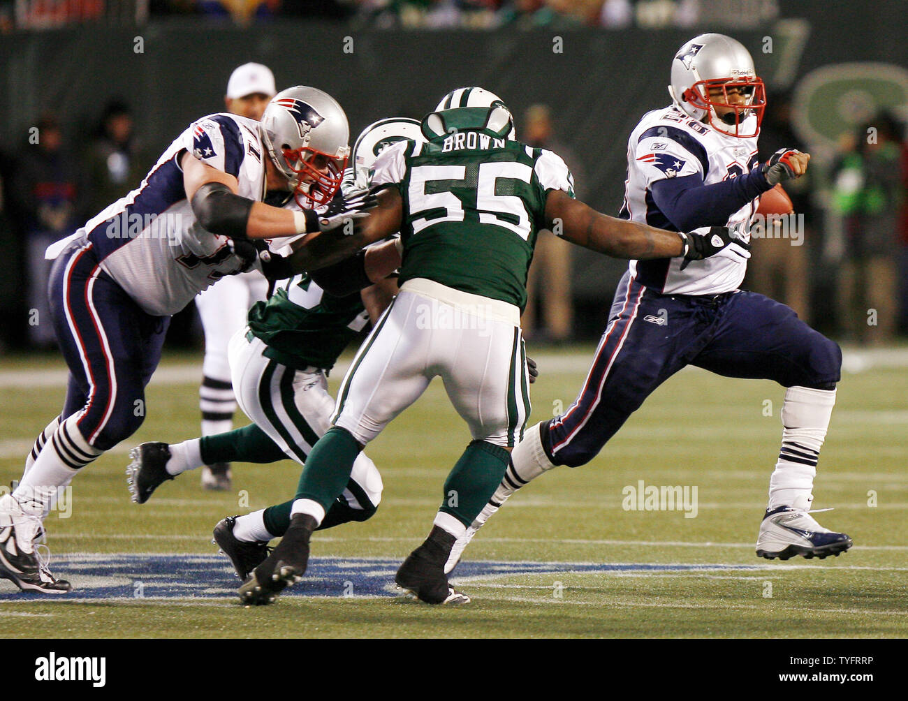 Corey Dillon of the New England Patriots shows the football after