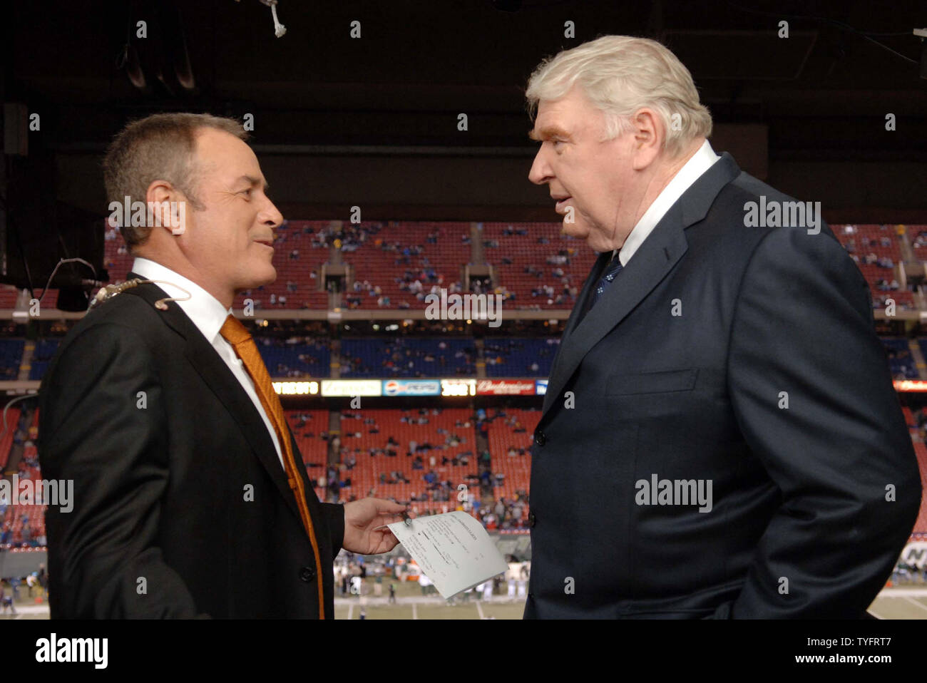 John Madden and Al Michaels exchange words during there last broadcast of ABC's Monday Night Football at Giants Stadium in East Rutherford, New Jersey on December 26, 2005. The New England Patriots defeated the New York Jets 21-7.  (UPI Photo/ Ida Mae Astute/ Pool) Stock Photo