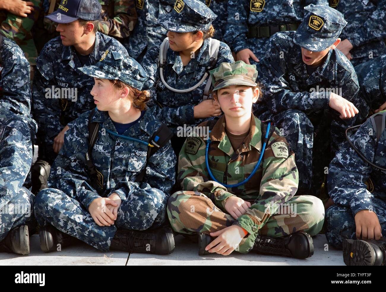 FORT PIERCE, Fla. (Nov. 6, 2016) U.S. Naval Sea Cadet Corps Seaman Recruit Terner, Palm Beach Division, waits for her shipmates to get settled for a group photo. Cadets are not required to join the armed services upon graduation; however, when they do, according to former Chief of Naval Operations Adm. Gary Roughead, each cadet who enlists saves the Navy more than $14,000 in life-cycle training costs. Stock Photo