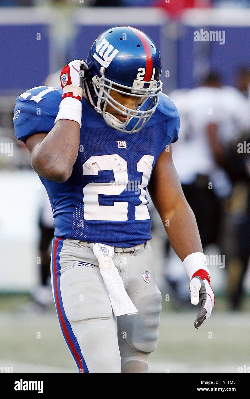 New York Giants Tiki Barber grabs his helmet as he walks off of the field  in the 4th quarter at Giants Stadium in East Rutherford, New Jersey on  December 24, 2006. The