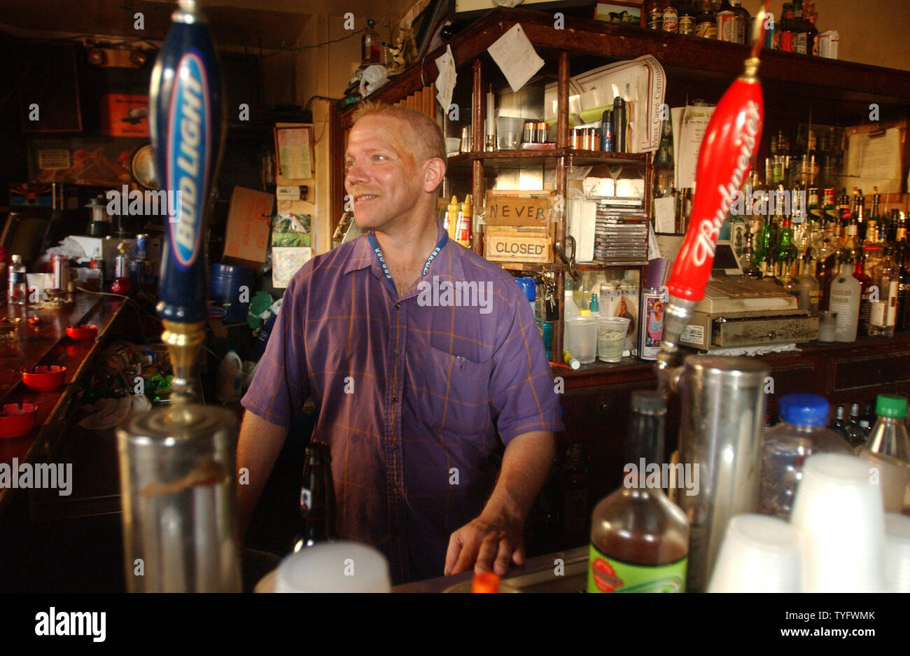 Denny Hooper tends bar in the French Quarter of New Orleans on Sept. 8, 2005. Although a large portion of the city remains innundated, residents and business owners have begun to clean up the damage caused by Hurricane Katrina in the drier areas.    (UPI Photo/Roger L. Wollenberg) Stock Photo
