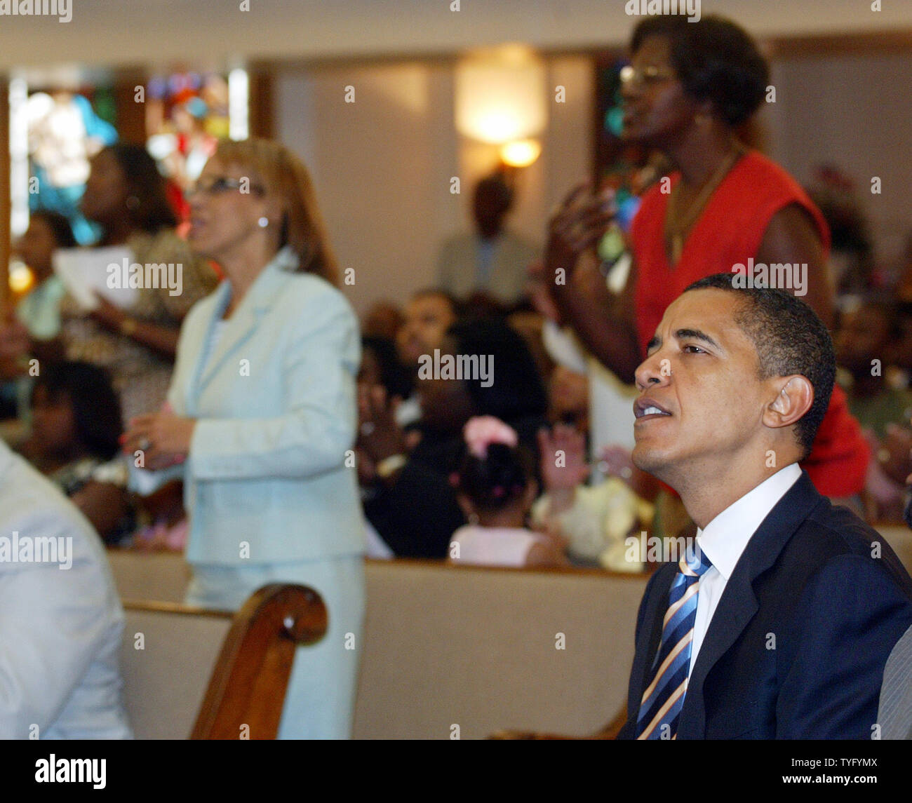 Sen. Barack Obama listens during worship services at First Emanuel
