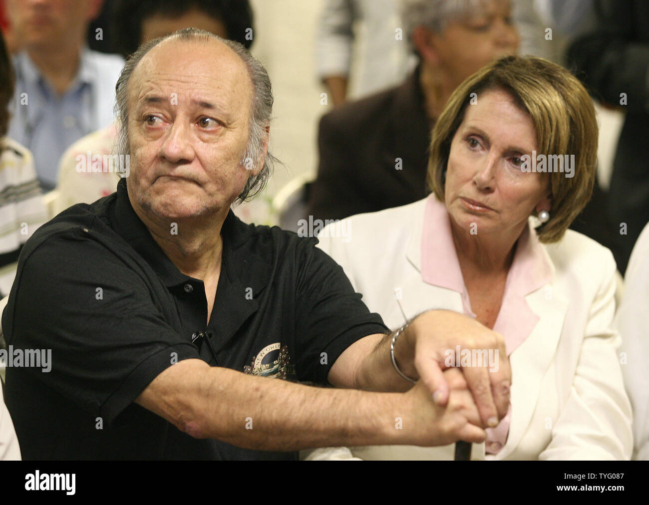 Ernie Novello and U.S. House Speaker Nancy Pelosi listen to a member of the audience at the Unity of Greater New Orleans, a advocacy group for the homeless, during a congressional tour of post-Katrina New Orleans as they gauge the rebuilding progress since Hurricane Katrina. Novello had been homeless until coming to the center.   (UPI Photo/A.J. Sisco) Stock Photo