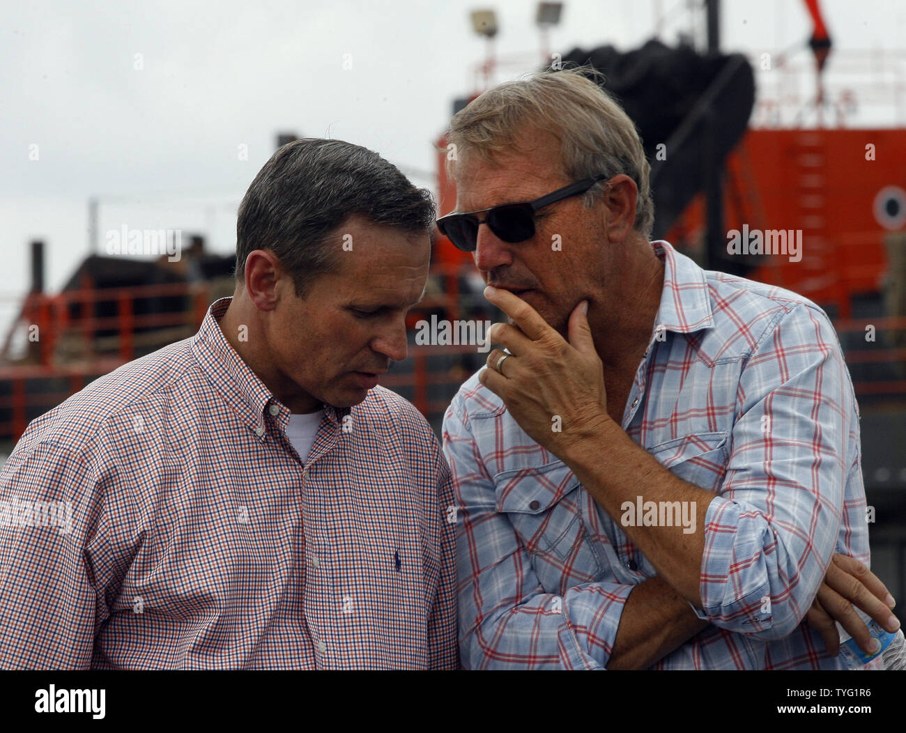 Kevin Costner, right, actor and founding partner of Ocean Therapy, talks with Doug Suttles,  chief operating officer of BP Exploration and Production, before a press conference in Port Fourchon, Louisiana, June 18, 2010. BP has purchased a centrifuge from Ocean Therapy that separates oil and water.   UPI/A.J. Sisco.. Stock Photo