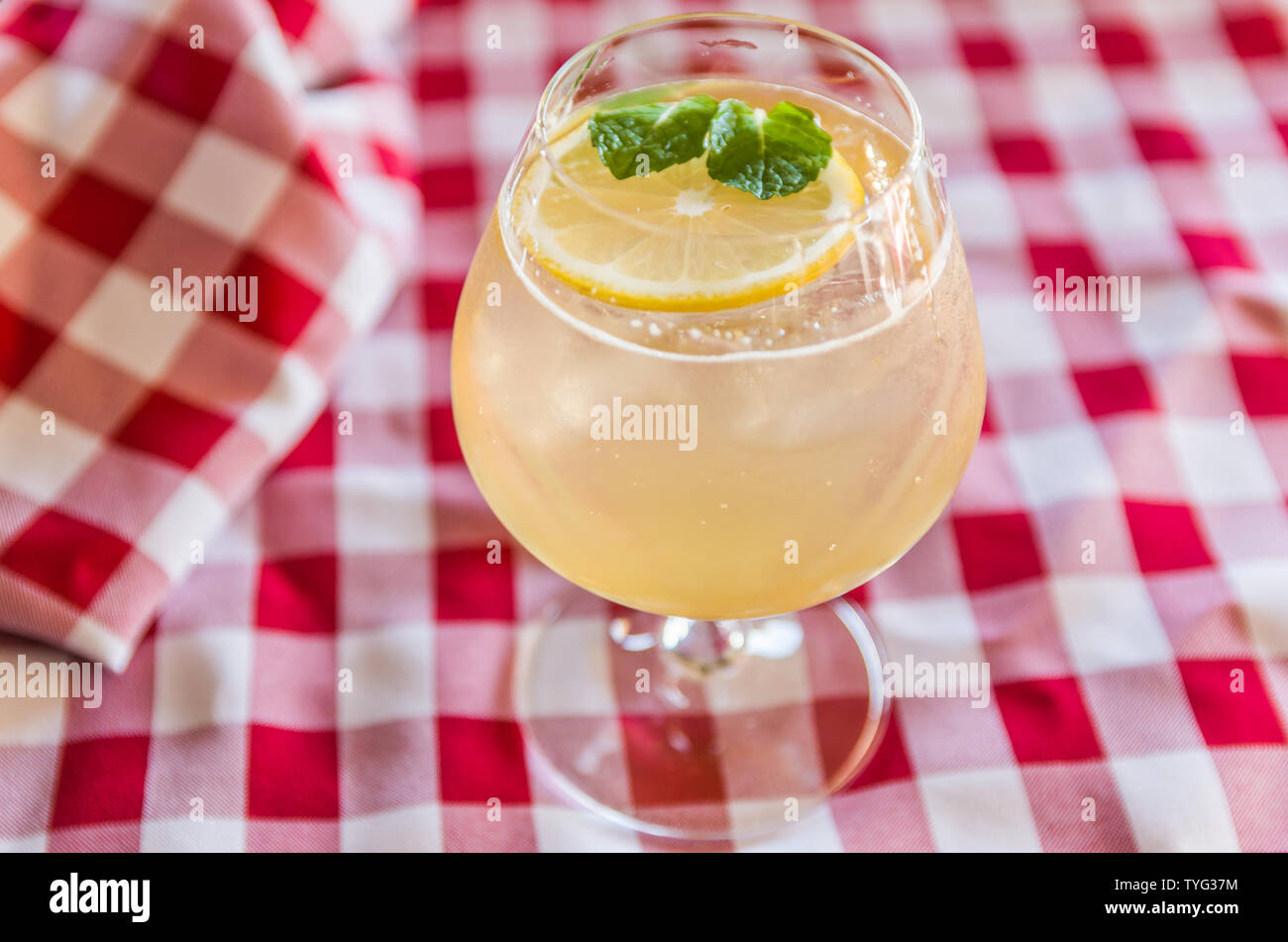 Beautiful kombucha cocktail of honey, ginger and lemon with vodka, decorated with mint leaf. Stock Photo