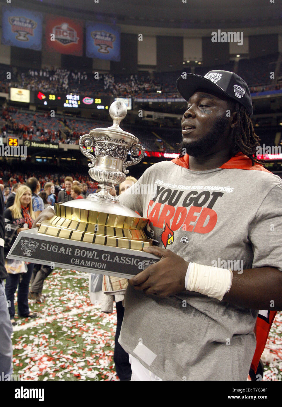 Louisville Cardinals defensive tackle Jamaine Brooks (99) carries the Sugar Bowl Trophy around the Superdome after the Cards beat the Florida Gators in the 79th Annual Allstate Sugar Bowl at the Mercedes-Benz Superdome in New Orleans, Louisiana, on January 2, 2013.  UPI/A.J. Sisco Stock Photo