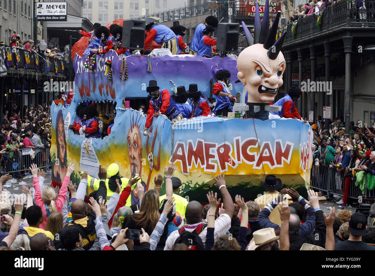 Spectators beg for prized Zulu coconuts and other trinkets as the Zulu parade rolls past St. Charles Avenue and Canal Street on Mardi Gras in New Orleans February 12, 2013. Parades rolled and the party went on despite sporadic showers.    UPI/A.J. Sisco Stock Photo