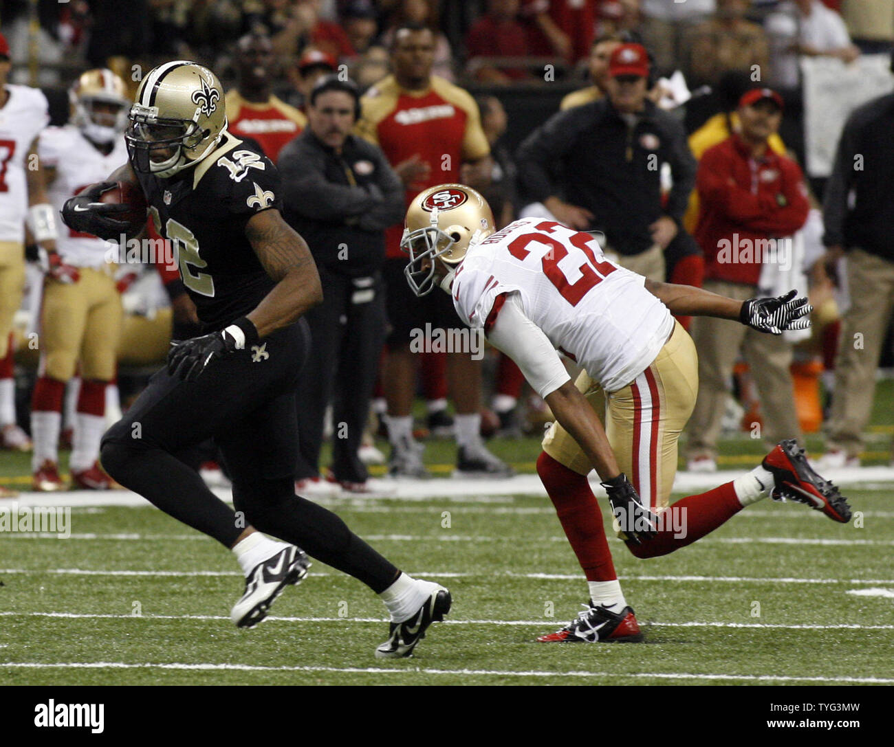 New Orleans Saints wide receiver Marques Colston (12) slips past San Francisco 49ers cornerback Carlos Rogers (22) for a 20 yard gain late in the fourth quarter at the Mercedes-Benz Superdome in New Orleans, Louisiana on November 17, 2013. Saints defeated the 49ers 23-20.  UPI/A.J. Sisco Stock Photo